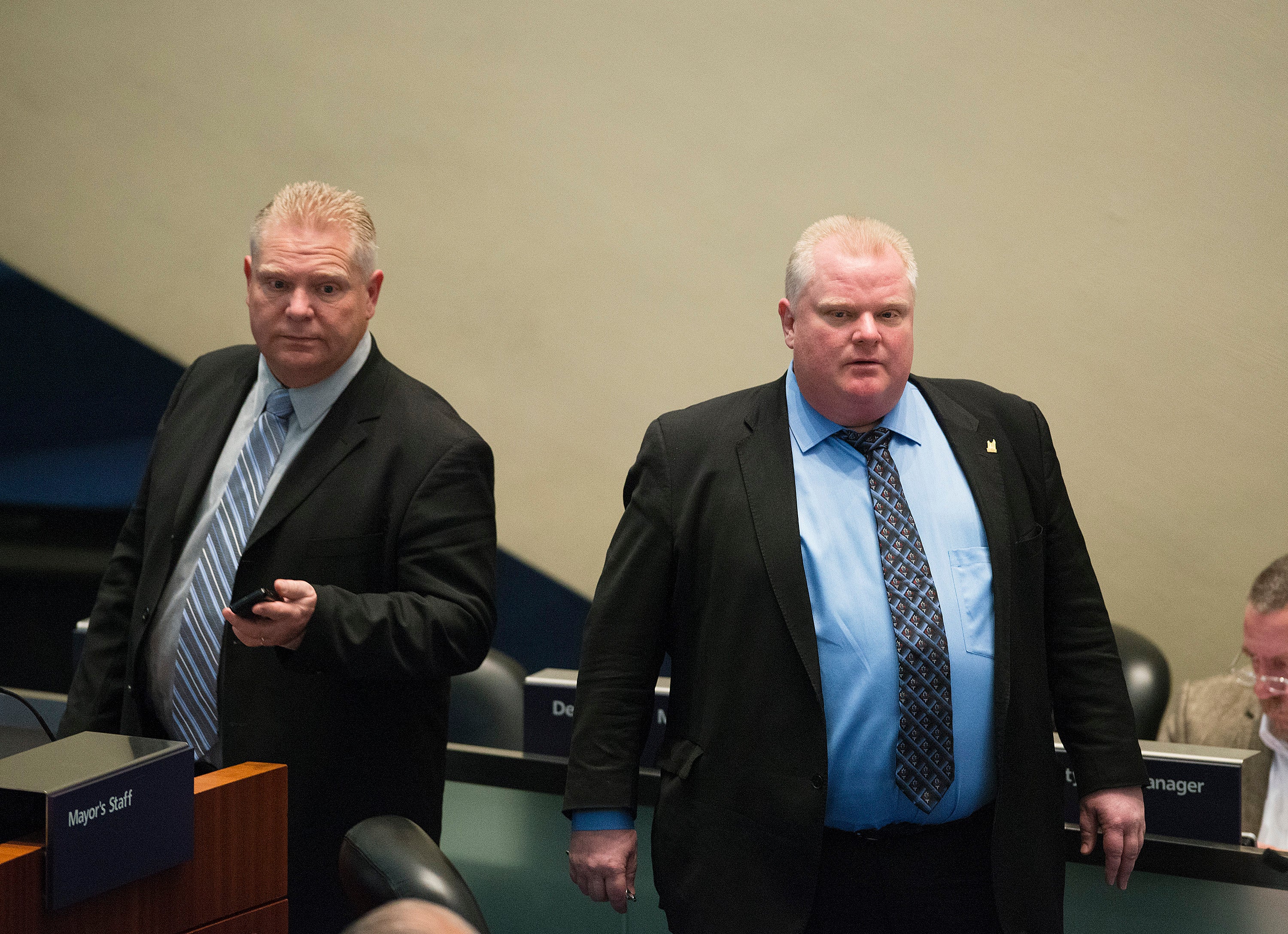 Toronto Mayor Rob Ford (right) stands next to his brother, councillor Doug Ford, during a Toronto City Council meeting