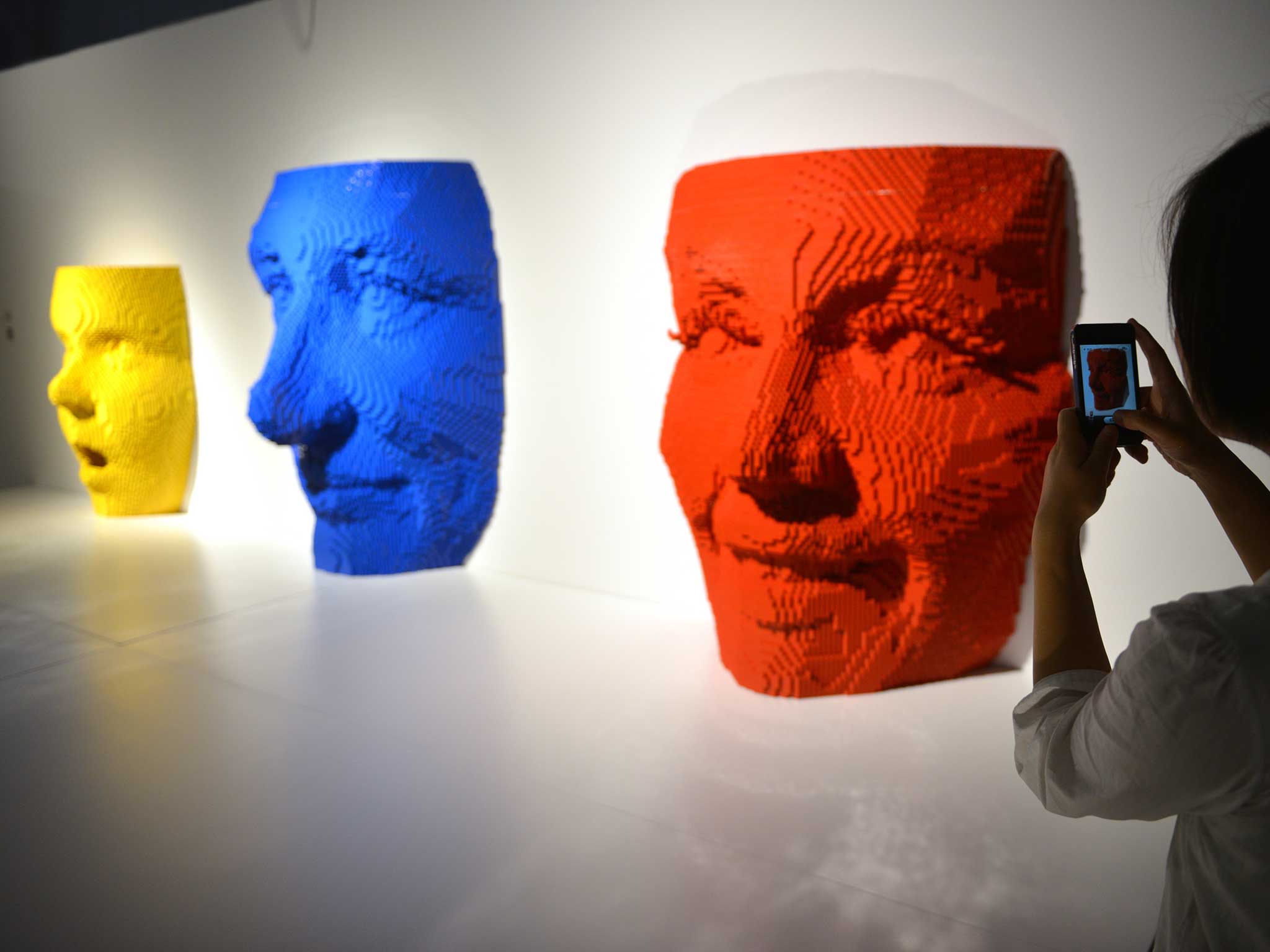 Lego sculptures entitled (L-R) 'Yellow Facemask, Red Facemask and Blue Facemask'' are displayed at the Art of Brick Exhibition (Getty Images)