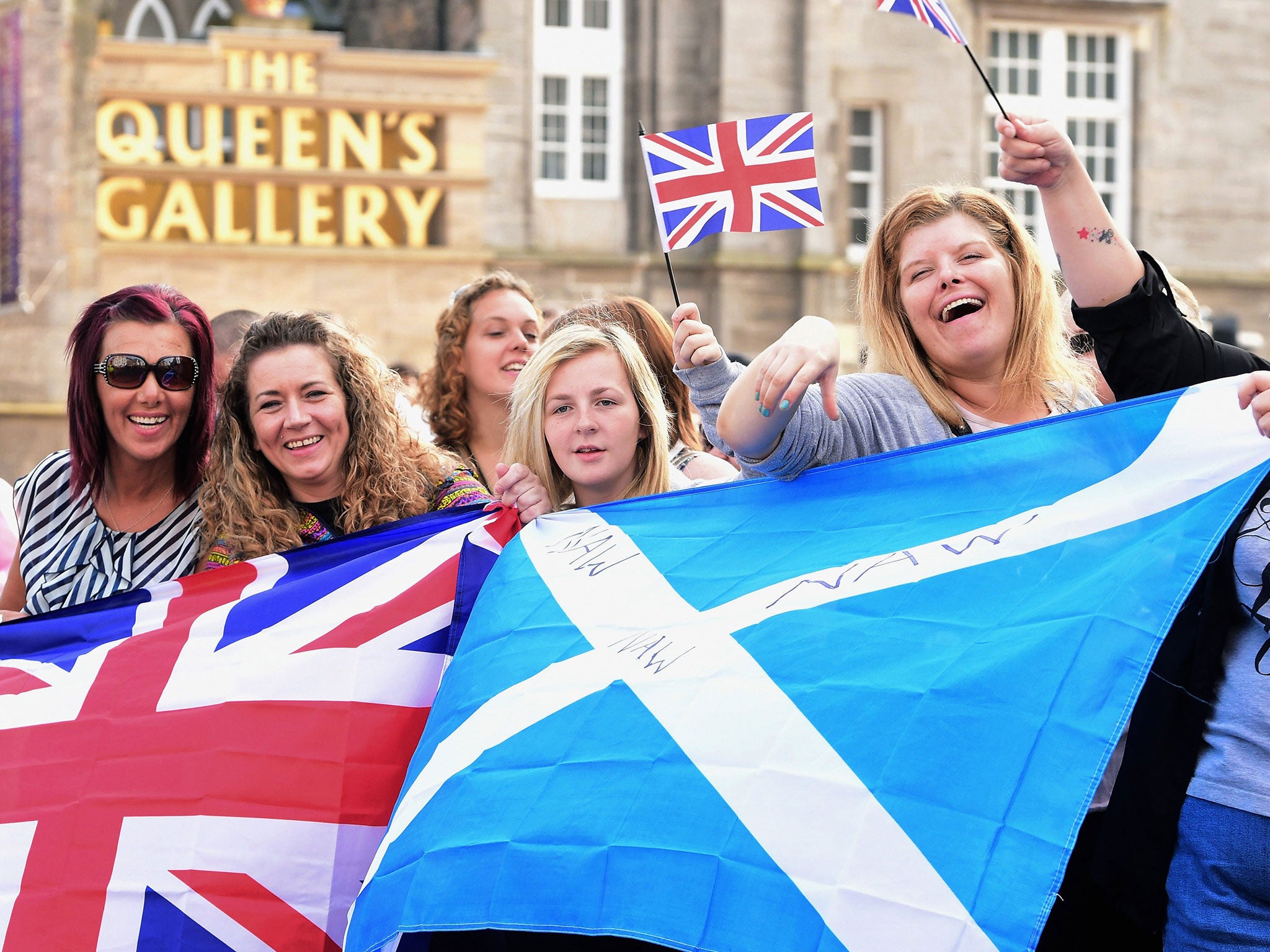 Members of the public watch Orangemen and women march during a pro union parade in Edinburgh, Scotland