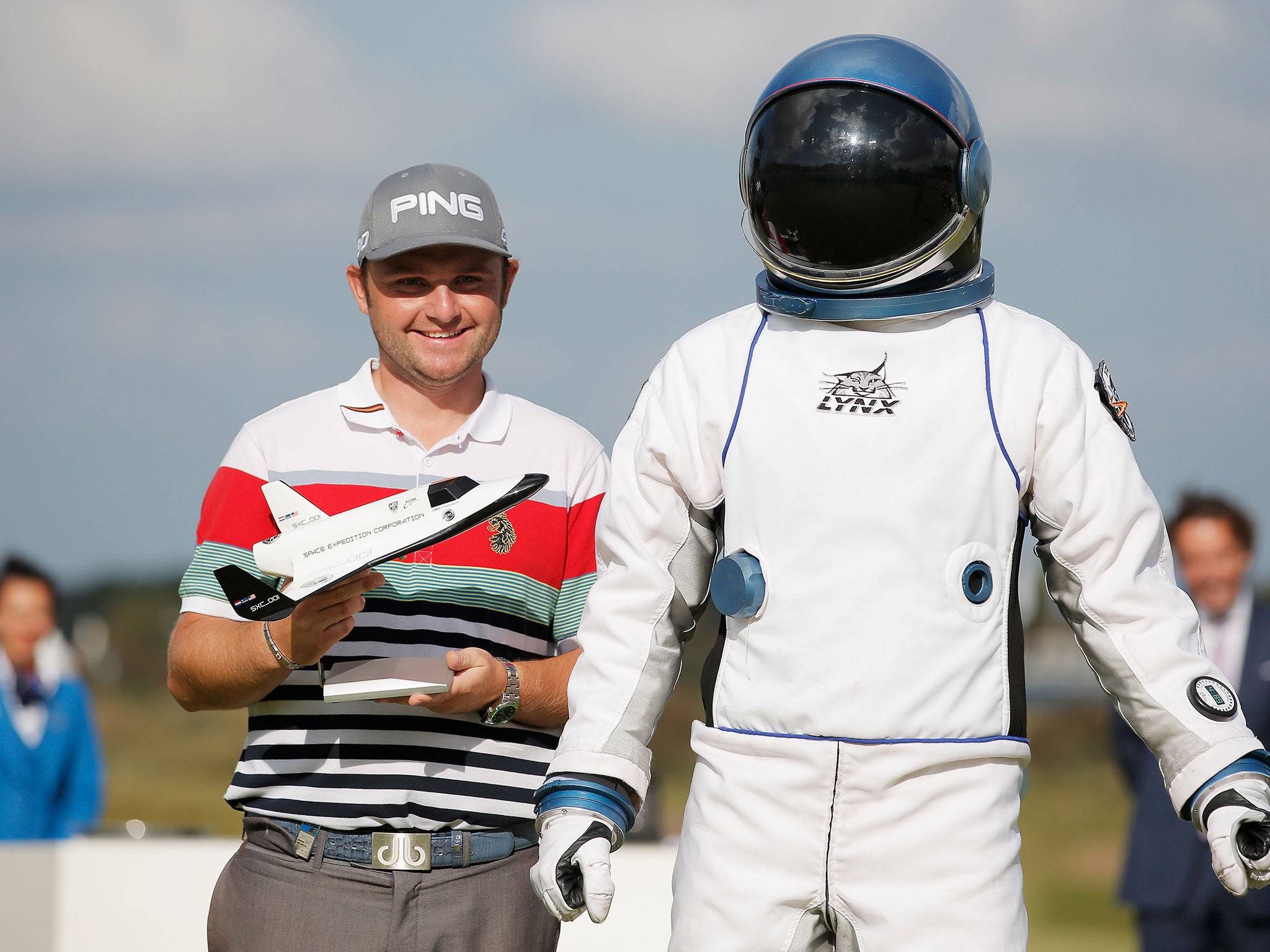 England's Andy Sullivan poses with his trophy and an astronaut after winning a trip to space