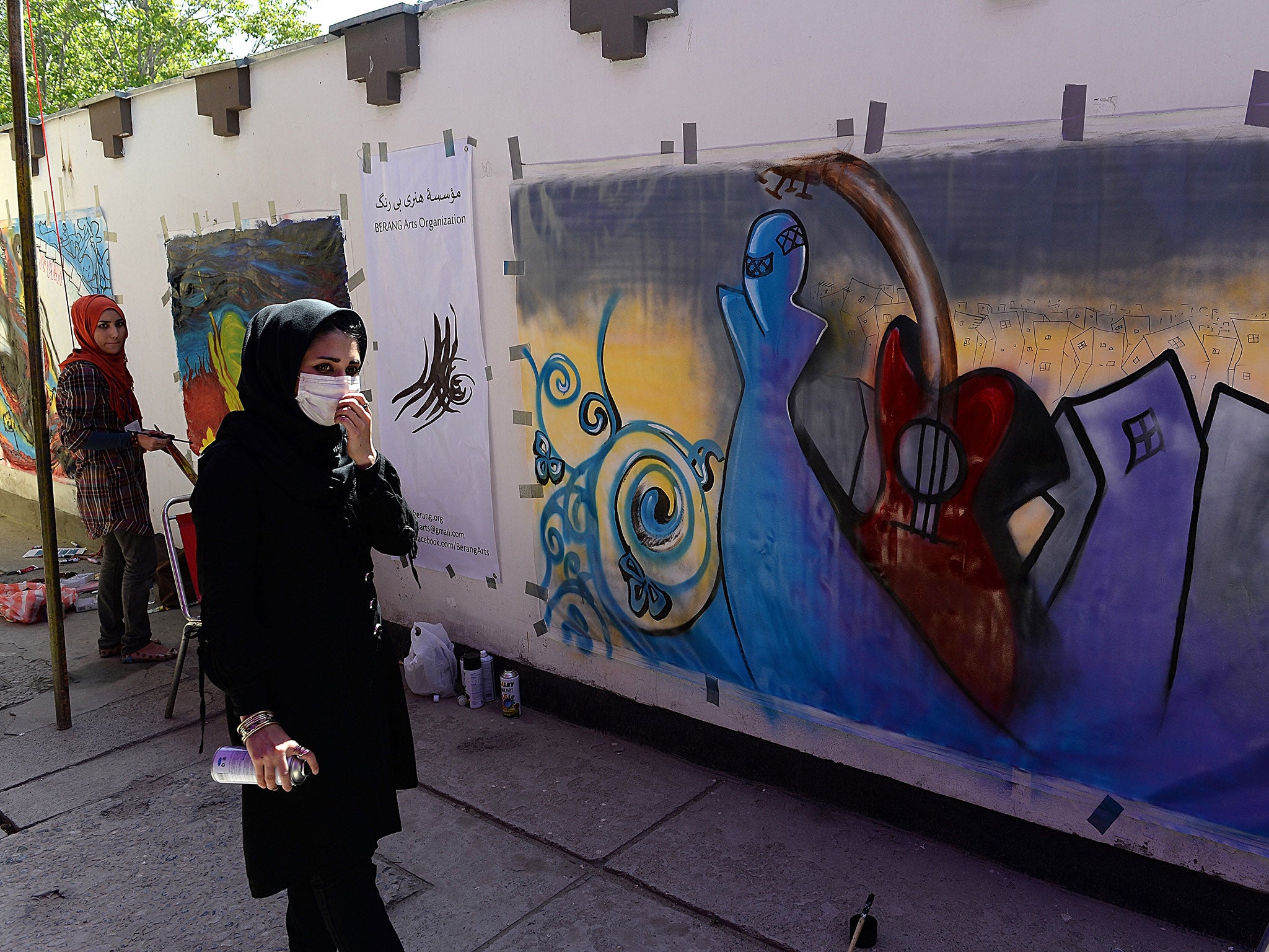 Shamsia Hassani painting one of her works – at the French Cultural Centre in Kabul