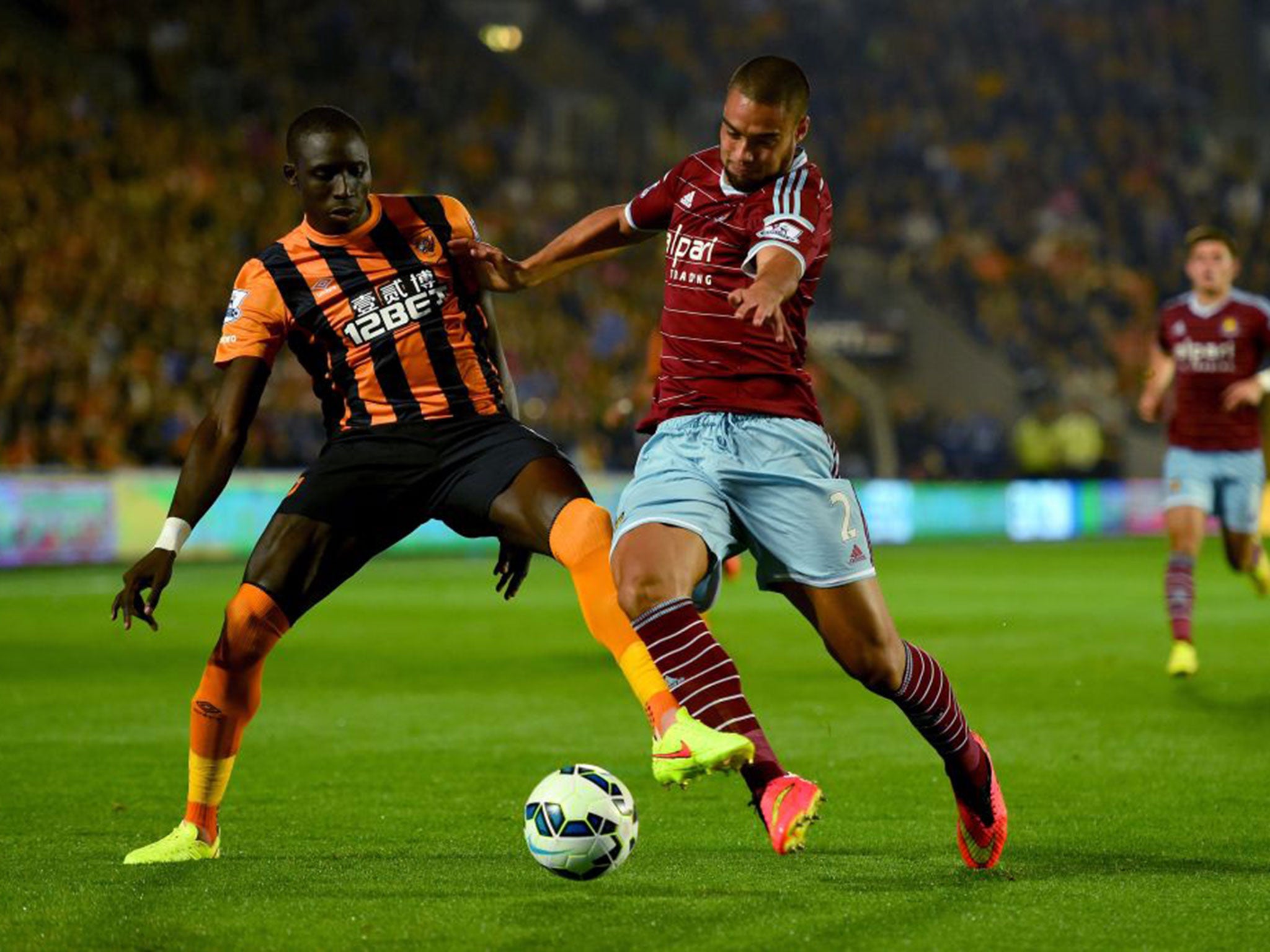 Hull's Mohamed Diame (left) challenges West Ham's inston Reid (right)