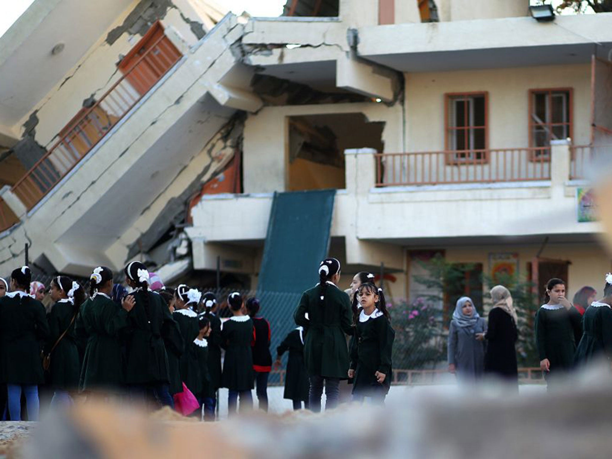 Palestinian pupils doing their morning exercise outside school on the first day of the new term in the Al-Sheiaeiya neigbourhood