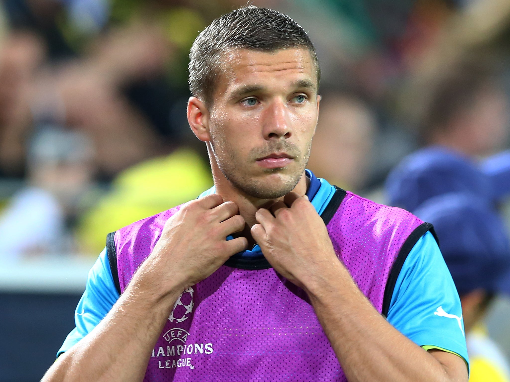 Lukas Podolski warms up during Arsenal's match against Borussia Dortmund