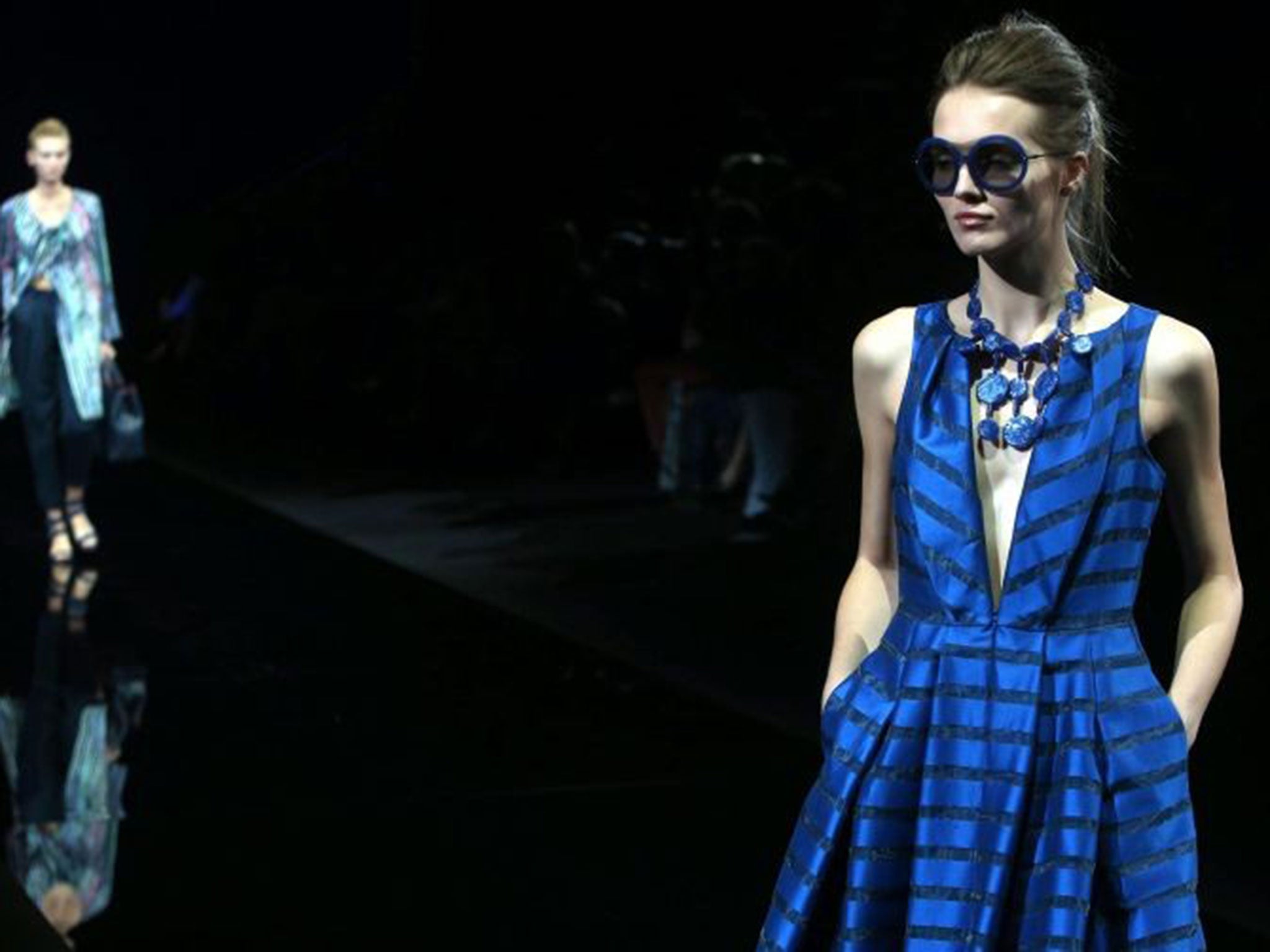 A model walks the catwalk during the Emporio Armani show as part of Milan Fashion Week spring/summer 2015