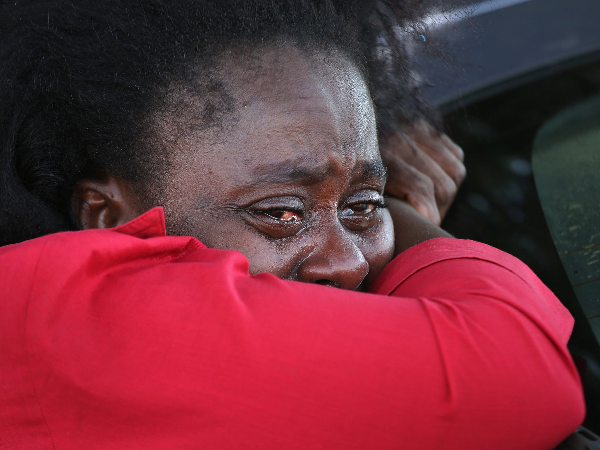 A woman weeps outside of the Doctors Without Borders Ebola treatment centre