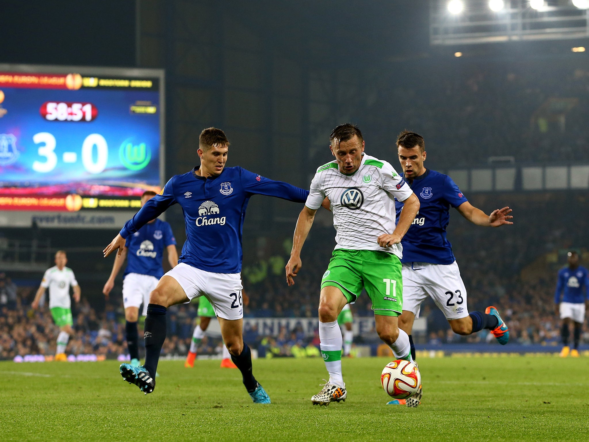 Ivica Olic of VfL Wolfsburg is closed down by John Stones (left) of Everton and Seamus Coleman (right)