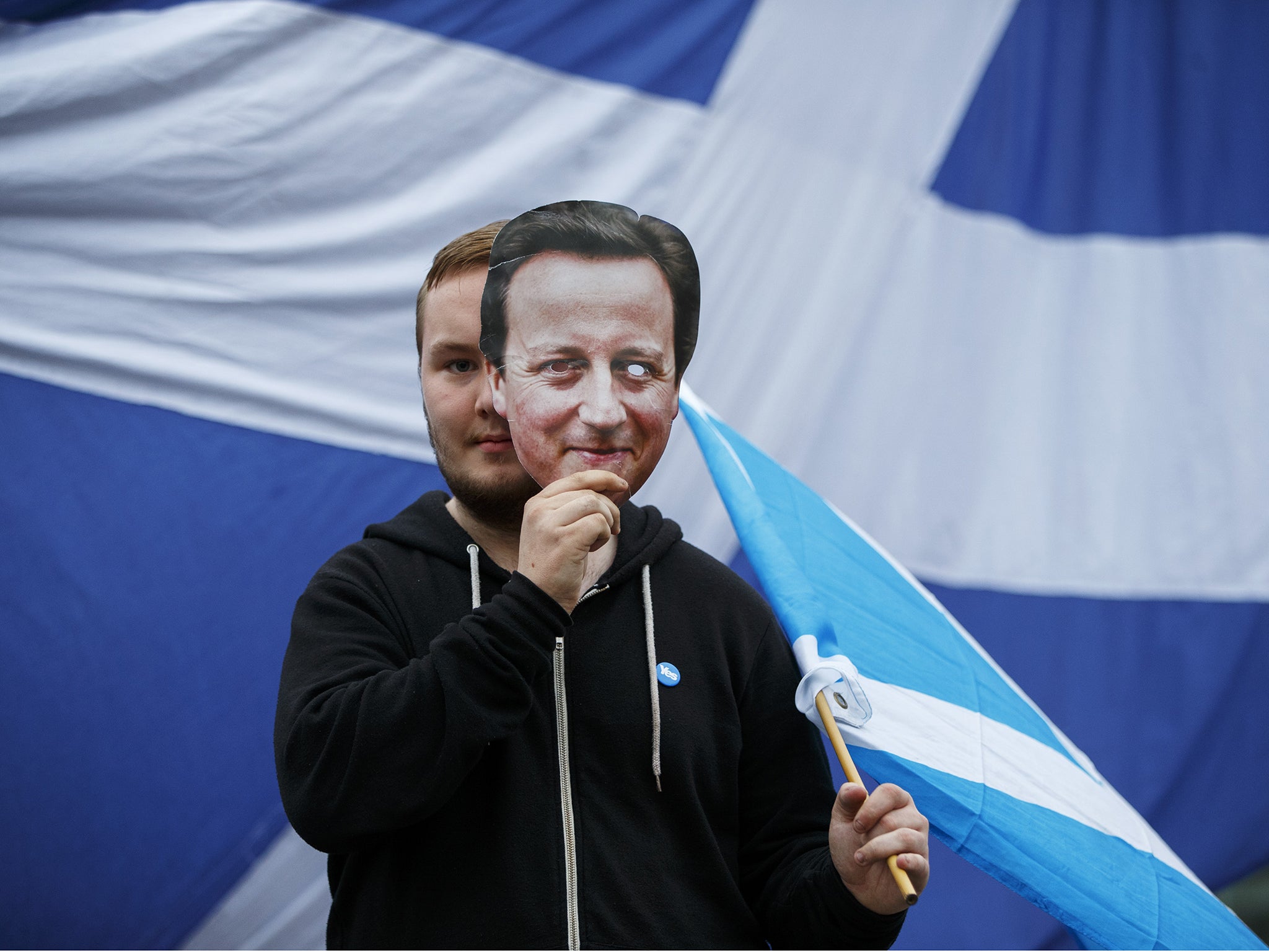 A disappointed 'Yes' campaigners reacting to Scotland's decision to stay in the union with a David Cameron mask at George Square in Glasgow