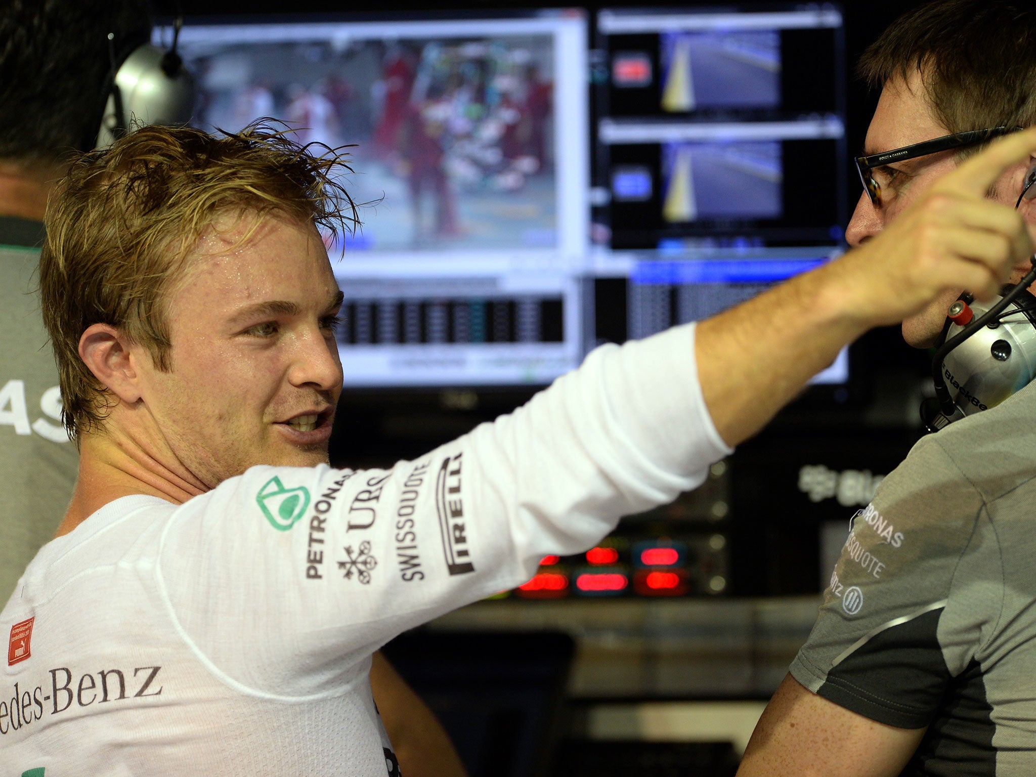 Nico Rosberg points something out to his engineer during first practice