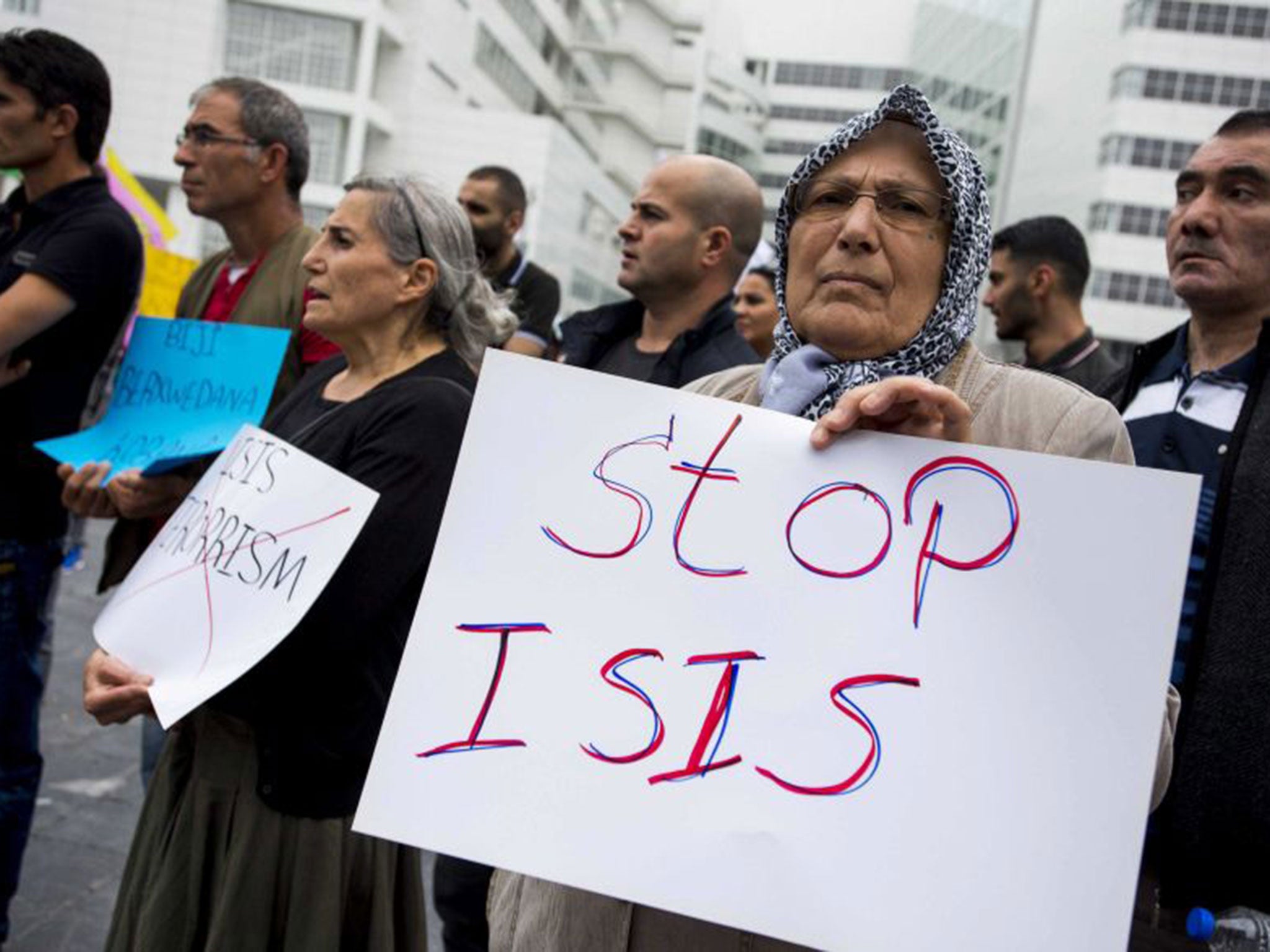 A supporter of the Kurdistan Workers' Association holds a placard during a demonstration against Islamic State (IS) in front The Hague