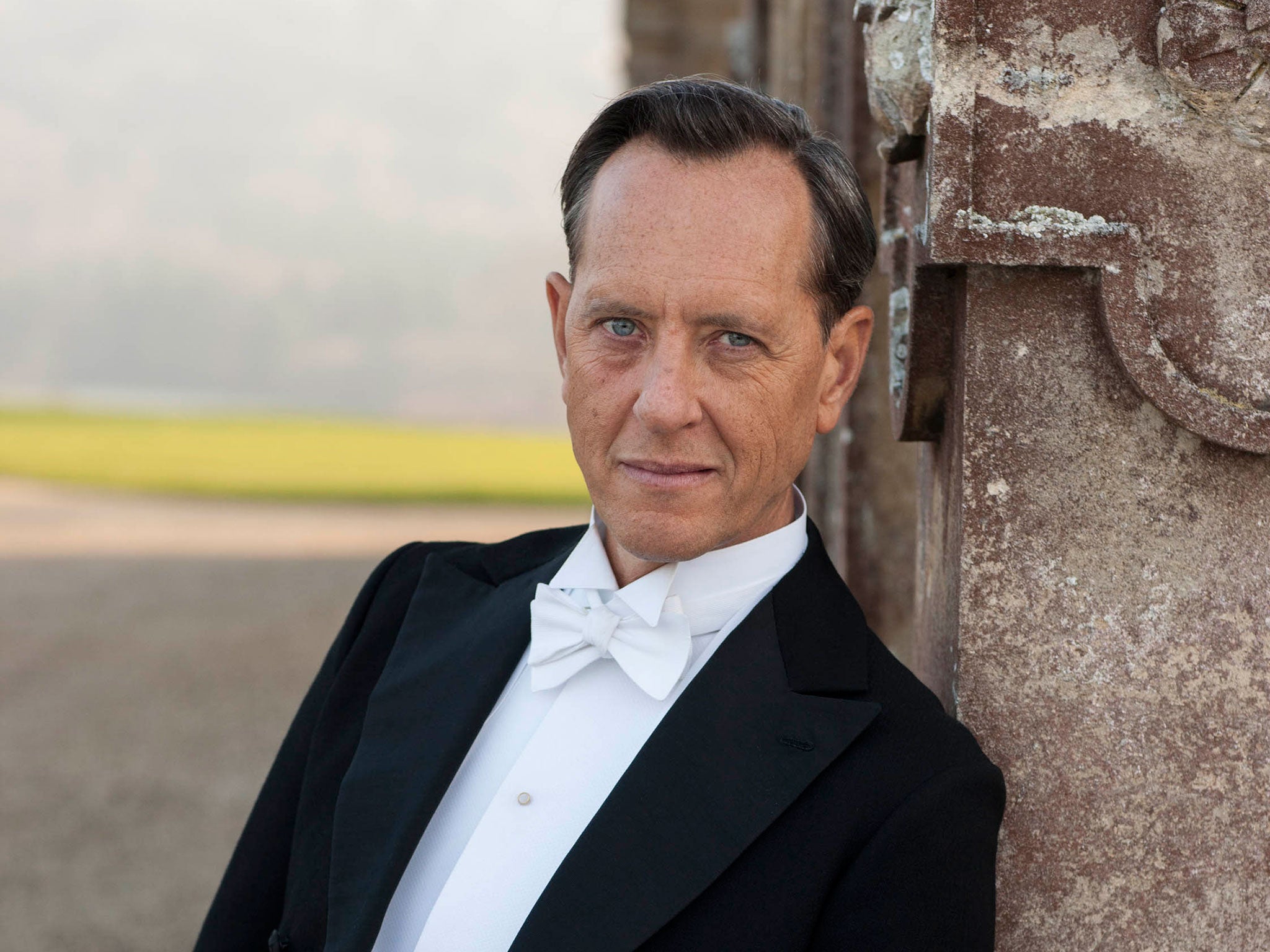 Richard E. Grant as art historian Simon Bricker