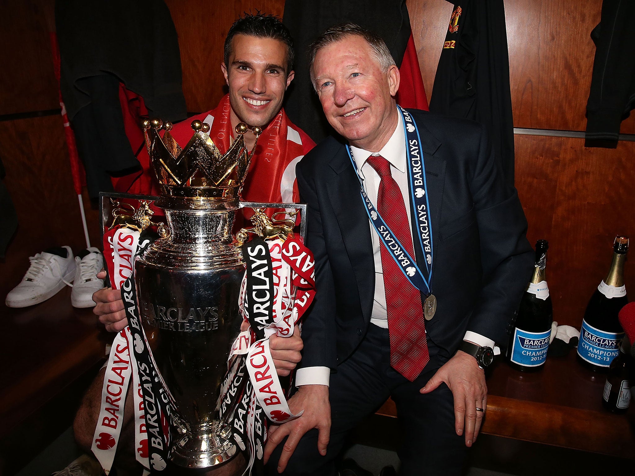 Robin van Persie holds the Premier League title alongside Sir Alex Ferguson