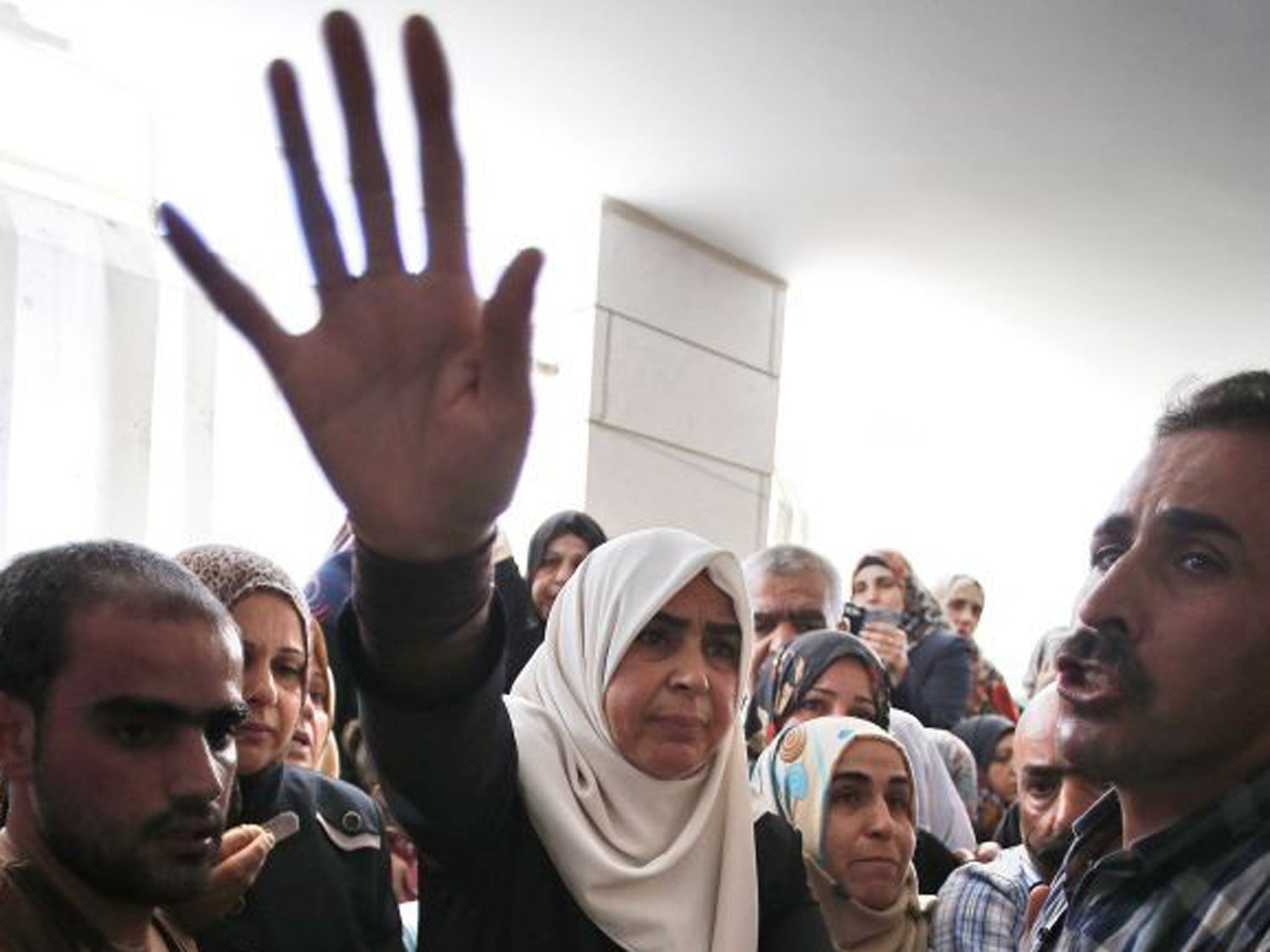 Marwan Qawasmeh's mother with her son’s body at his funeral yesterday