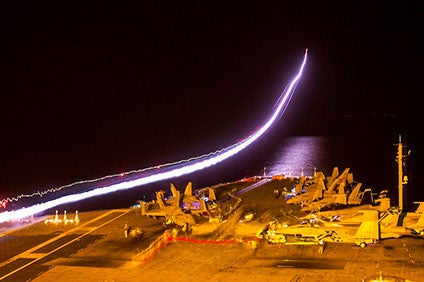 An EA-18G Growler takes off from the flight deck of the aircraft carrier USS George Washington