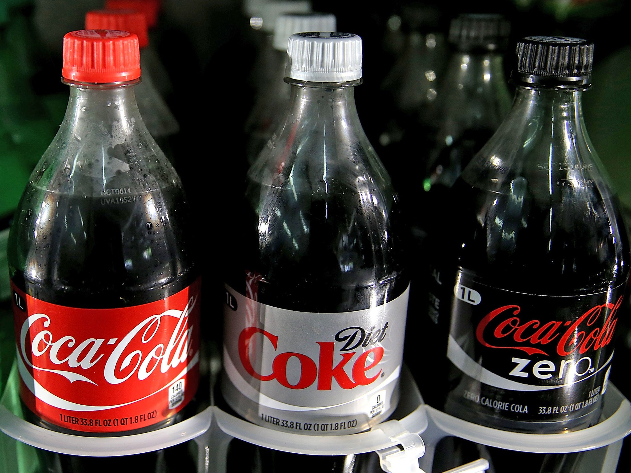 Coca Cola products are displayed in a cooler