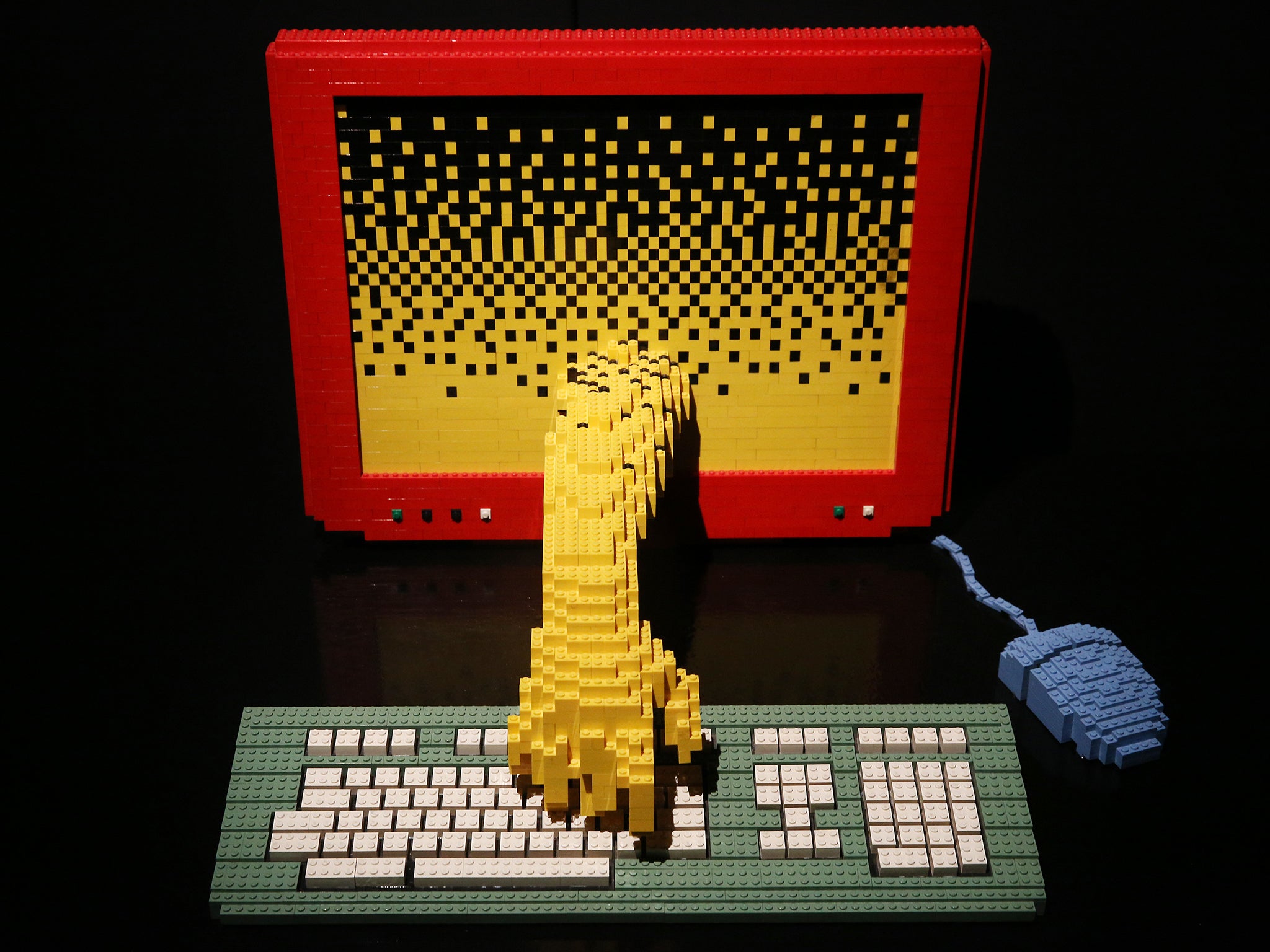 A Lego sculpture entitled 'Computer' is displayed at the Art of Brick Exhibition in London (Artist Nathan Sawaya stands with his sculpture 'Yellow' at the Art of Brick Exhibition)