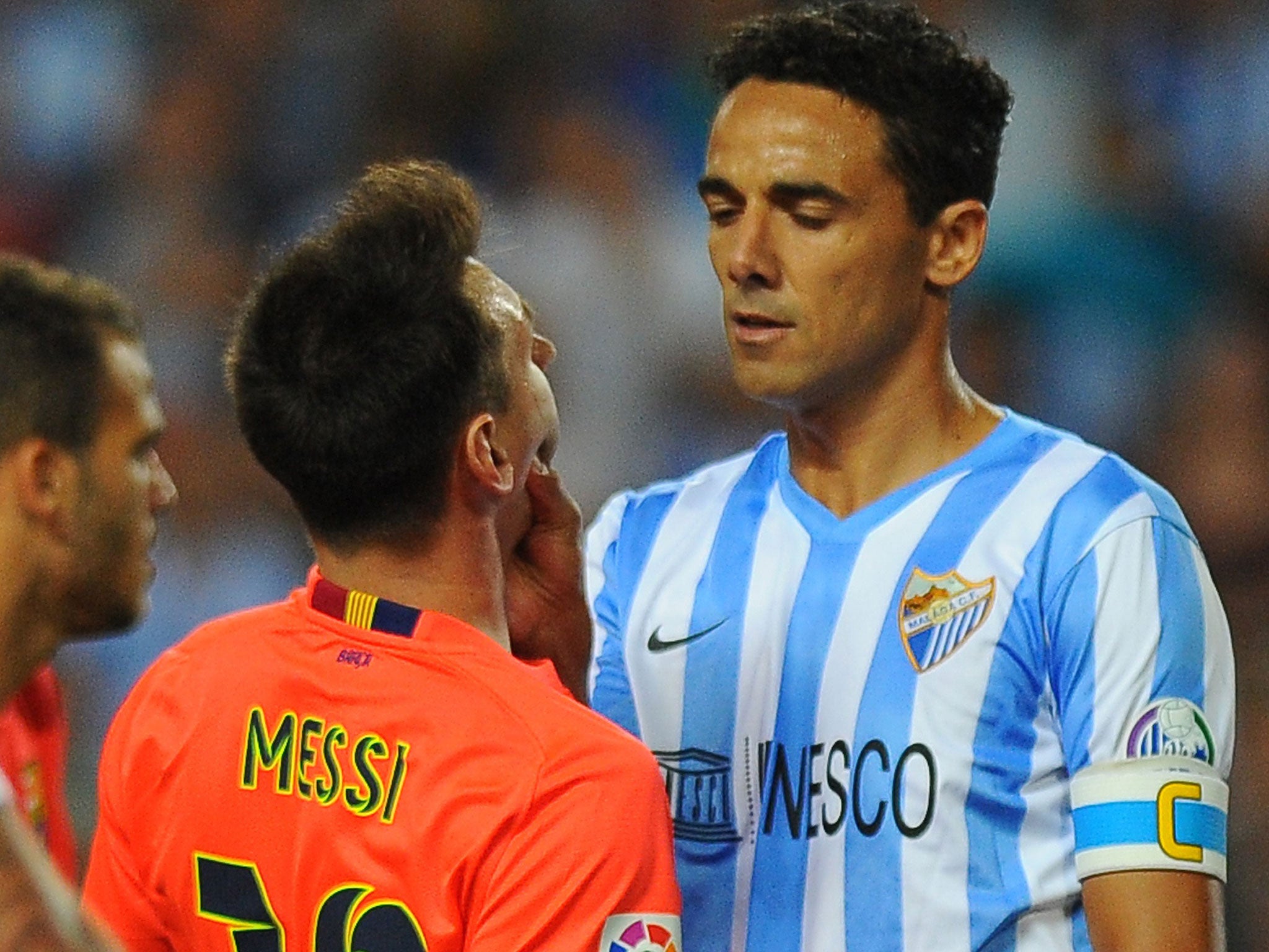 Lionel Messi (left) clashes with Weligton last night