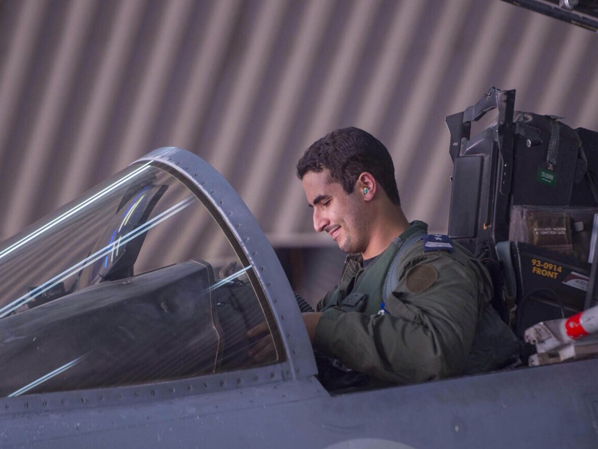 Saudi Arabian air force pilot Prince Khaled bin Salman sits in the cockpit of a fighter jet at an undisclosed location on September 23, 2014