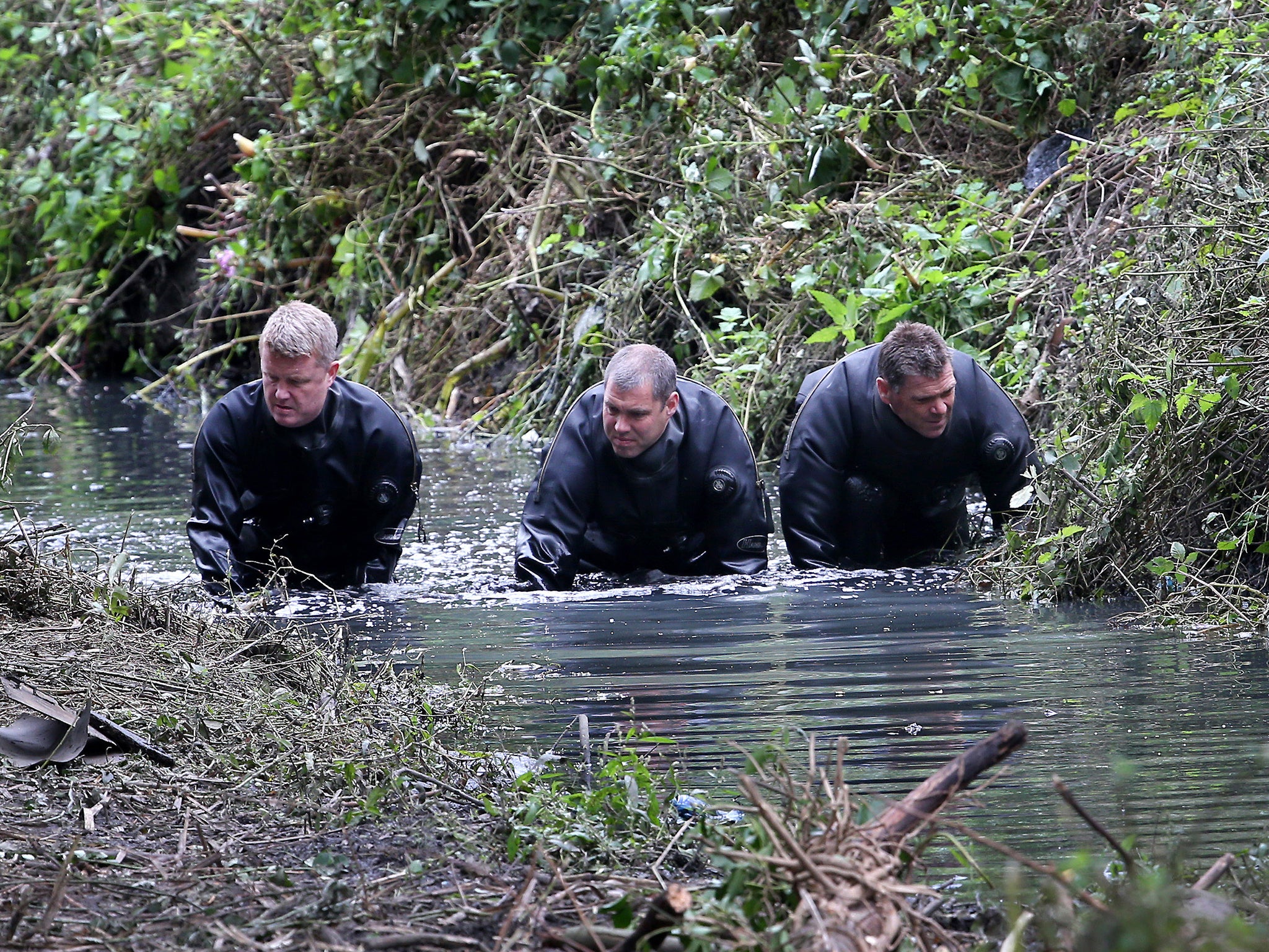 Police divers search the river Brent for clues in the hunt for missing school girl Alice Gross in London