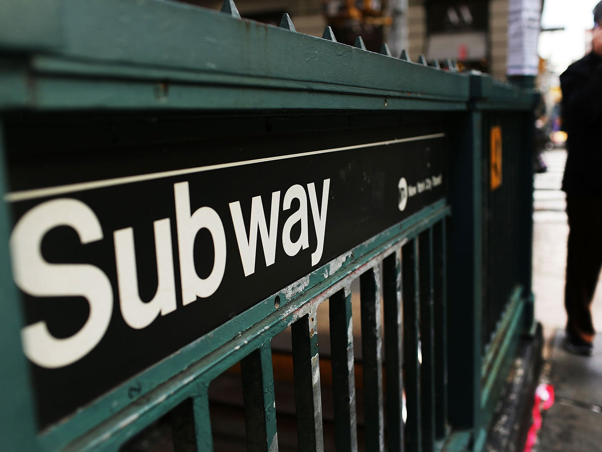 A man walks past a subway stop in Manhattan. It is unclear whether the subway was among potential US targets.