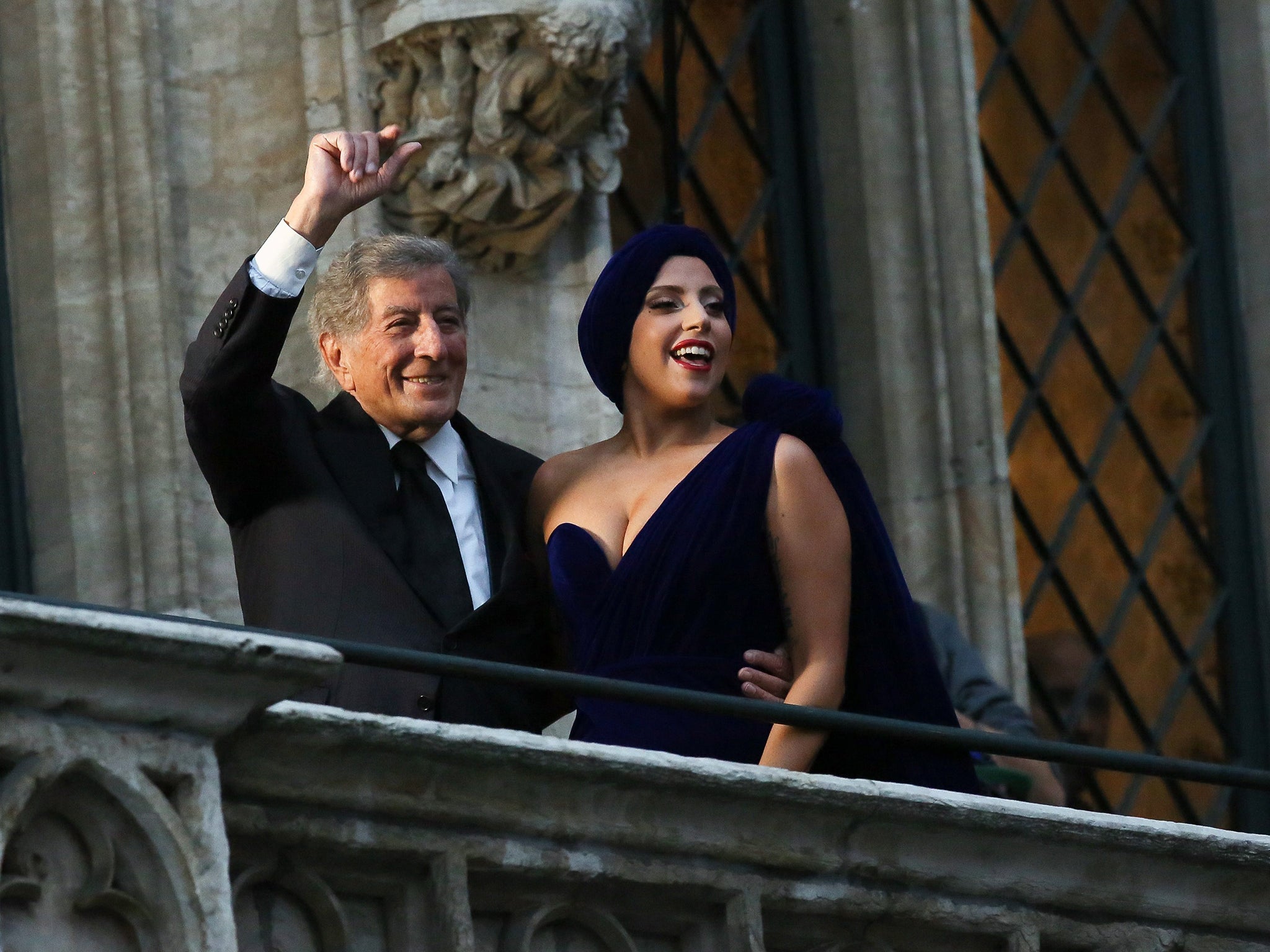 US singers Lady Gaga (R) and Tony Bennett stand on the balcony of the city hall in Brussels, Belgium