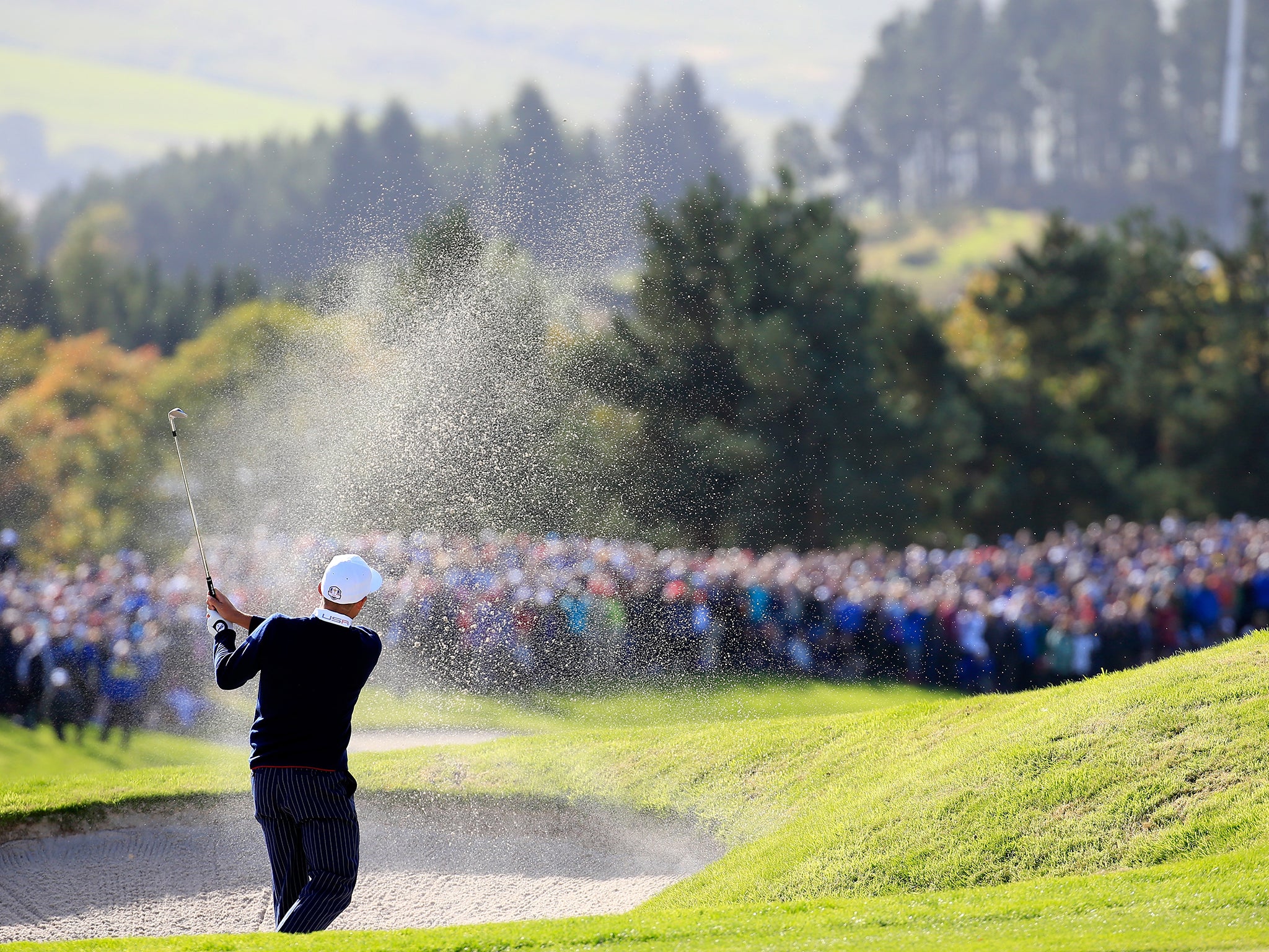 Fowler chips from the bunker on the 16th hole during the first session