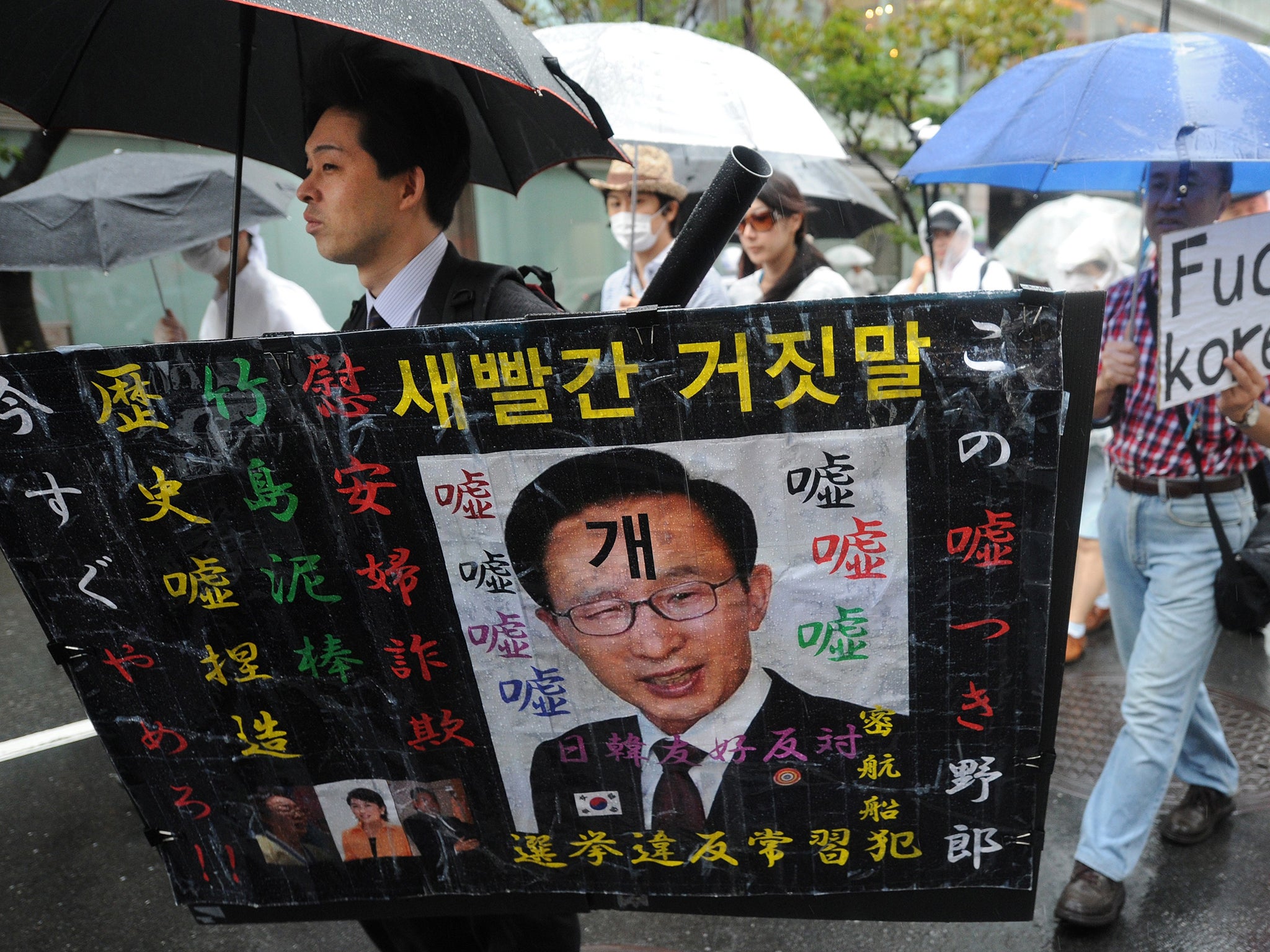 Zaitokukai members wave racist placards during an
anti-Korean rally in Tokyo