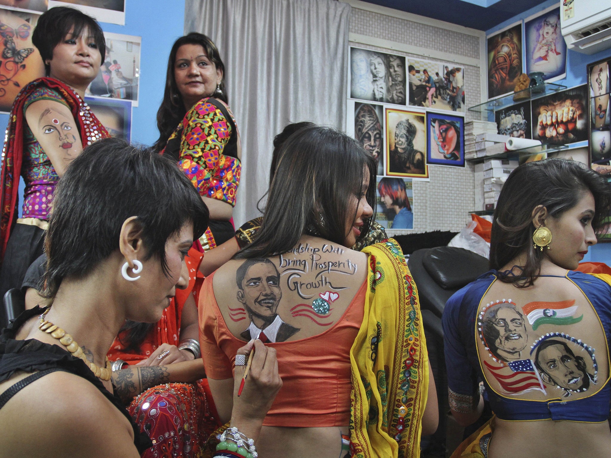 Women in Ahmedabad, capital of the Indian Prime Minister Narendra Modi’s home state of Gujarat, celebrate the beginning of his visit to the US. He will address the UN and meet Barack Obama