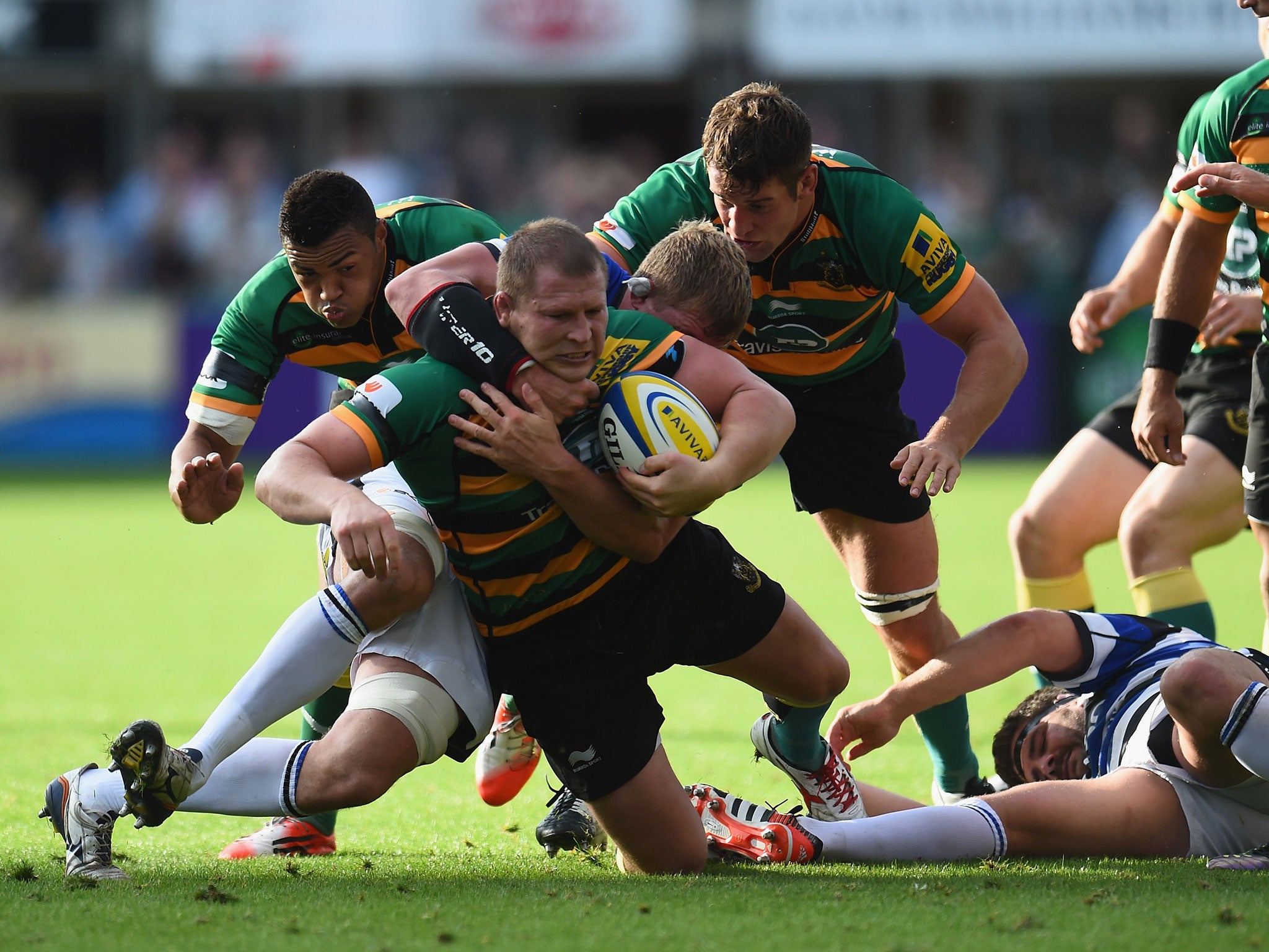 Dylan Hartley is tackled by Stuart Hooper