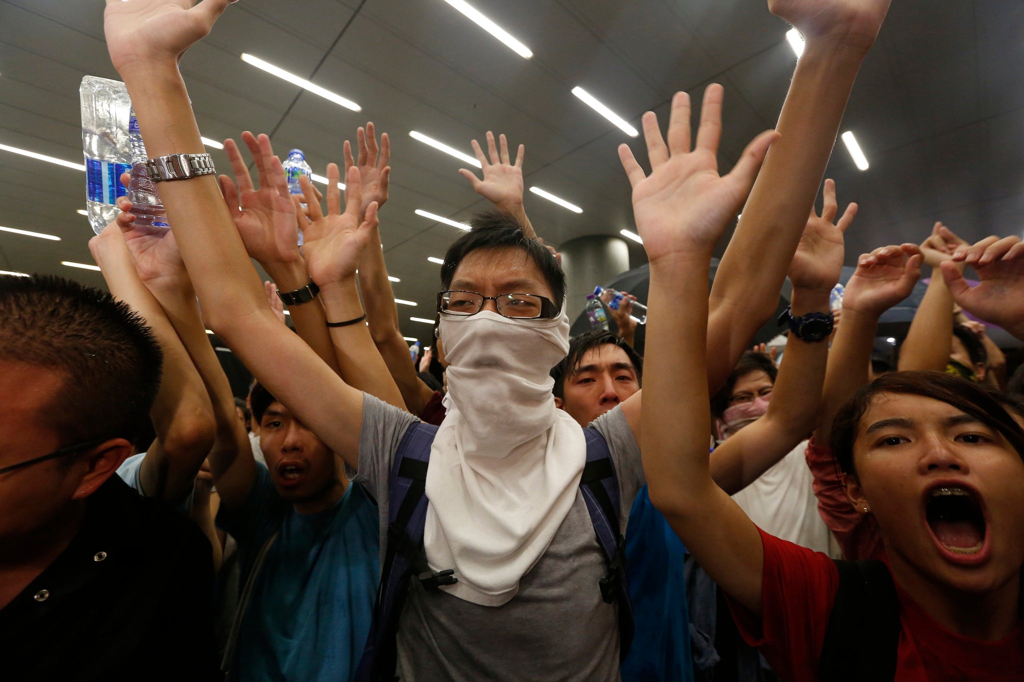 Protesters chant slogans in front of the police