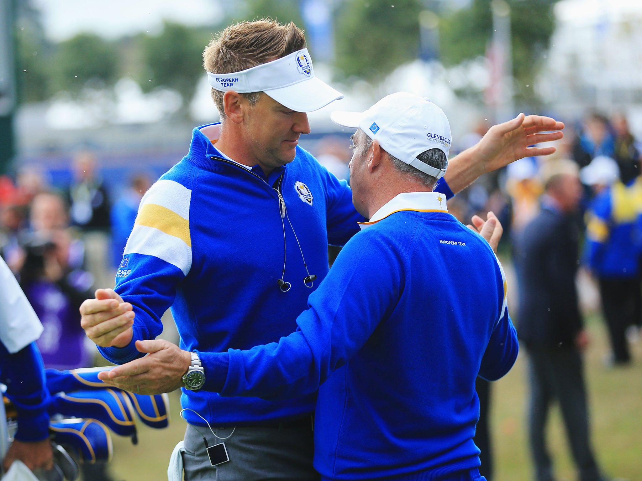 Ian Poulter of Europe hugs Europe team captain Paul McGinley on the 1st tee