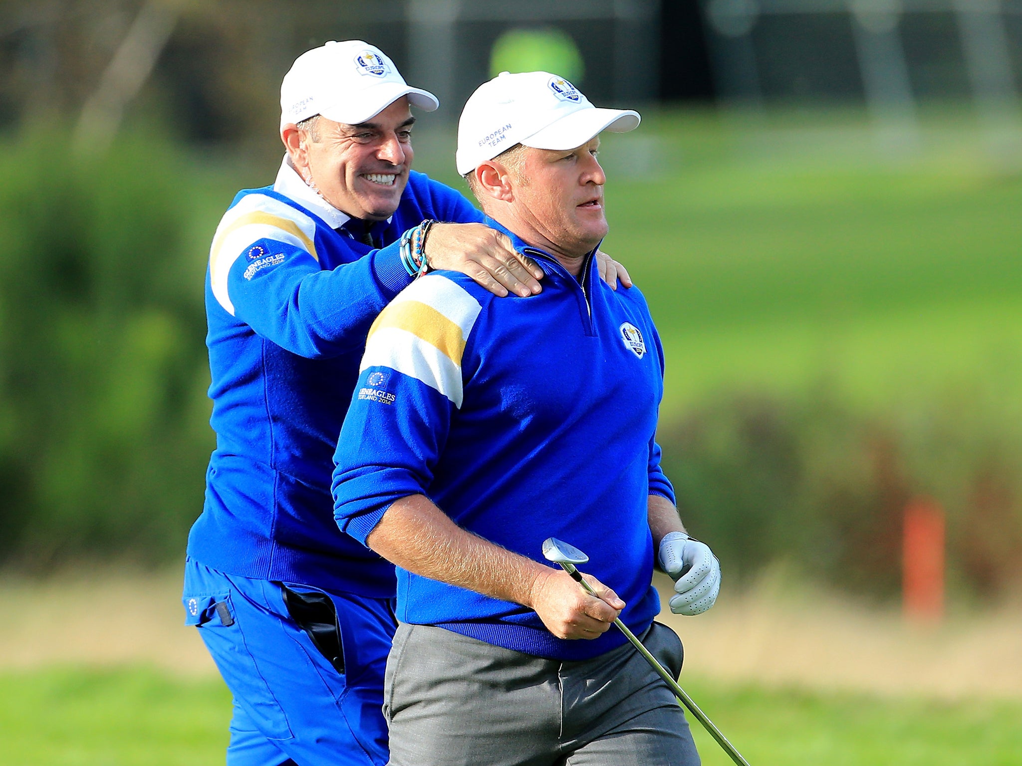 Jamie Donaldson of Europe is congratulated by Europe team captain Paul McGinley on the 15th hole shortly before Europe won the Ryder Cup