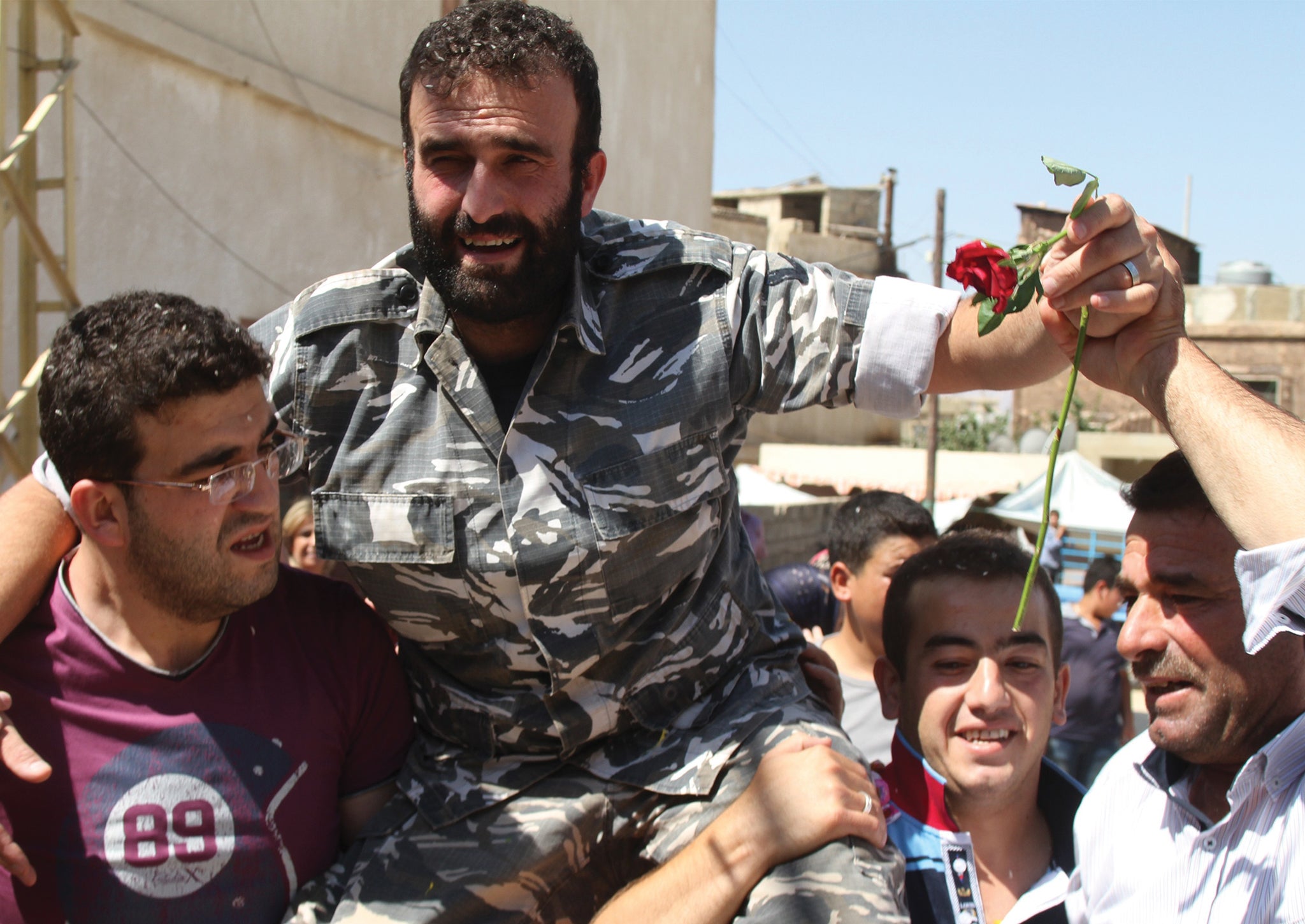 Saleh al-Baradei, a Lebanese police officer kidnapped along with four soldiers by the Al-Nusra Front, the Syrian branch of Al-Qaeda, celebrates with relatives after his release on August 31, 2014