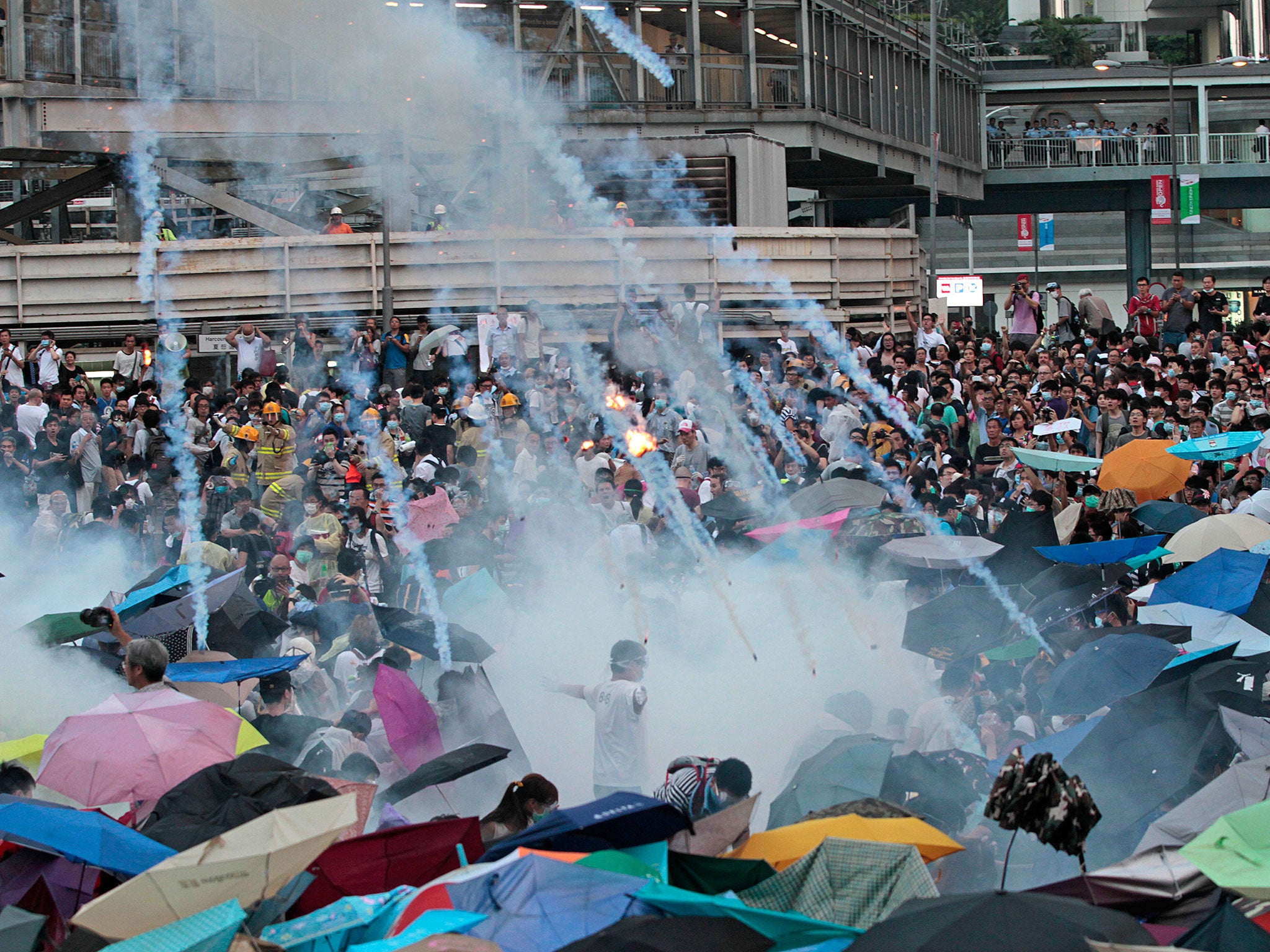 Images such as this one showing riot police launching tear gas into the crowd are raising the stakes of the face-off