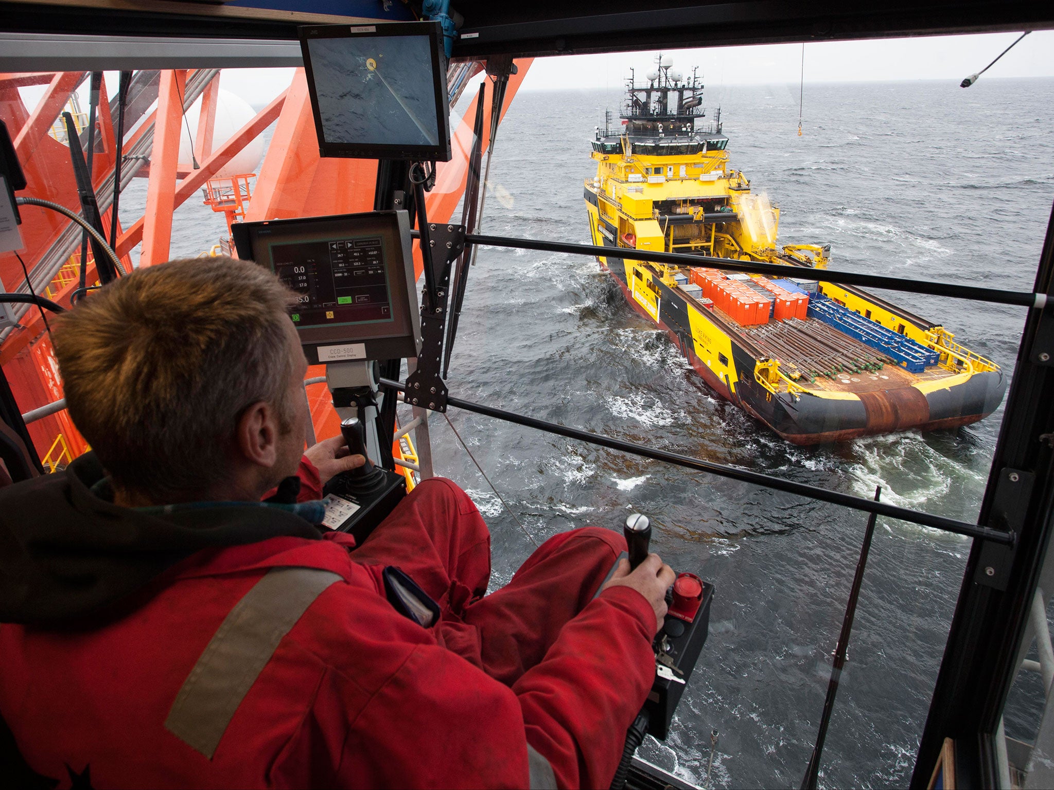 A worker controls arrival of a supply ship to the West Alfa drilling platform, which is anchored at the Cara Sea some 250 km (156 miles) north off Russian shore