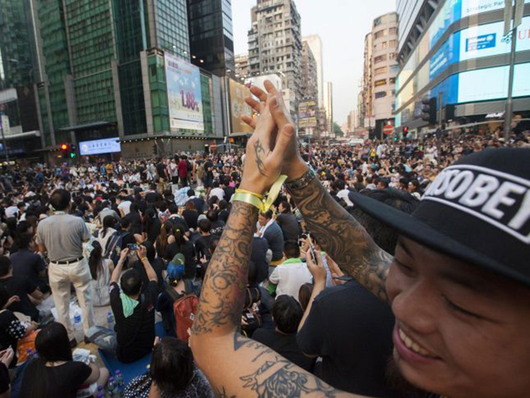 Up to ten thousand protesters donned yellow ribbons whilst blocking up roads in the shopping district of Mong Kok