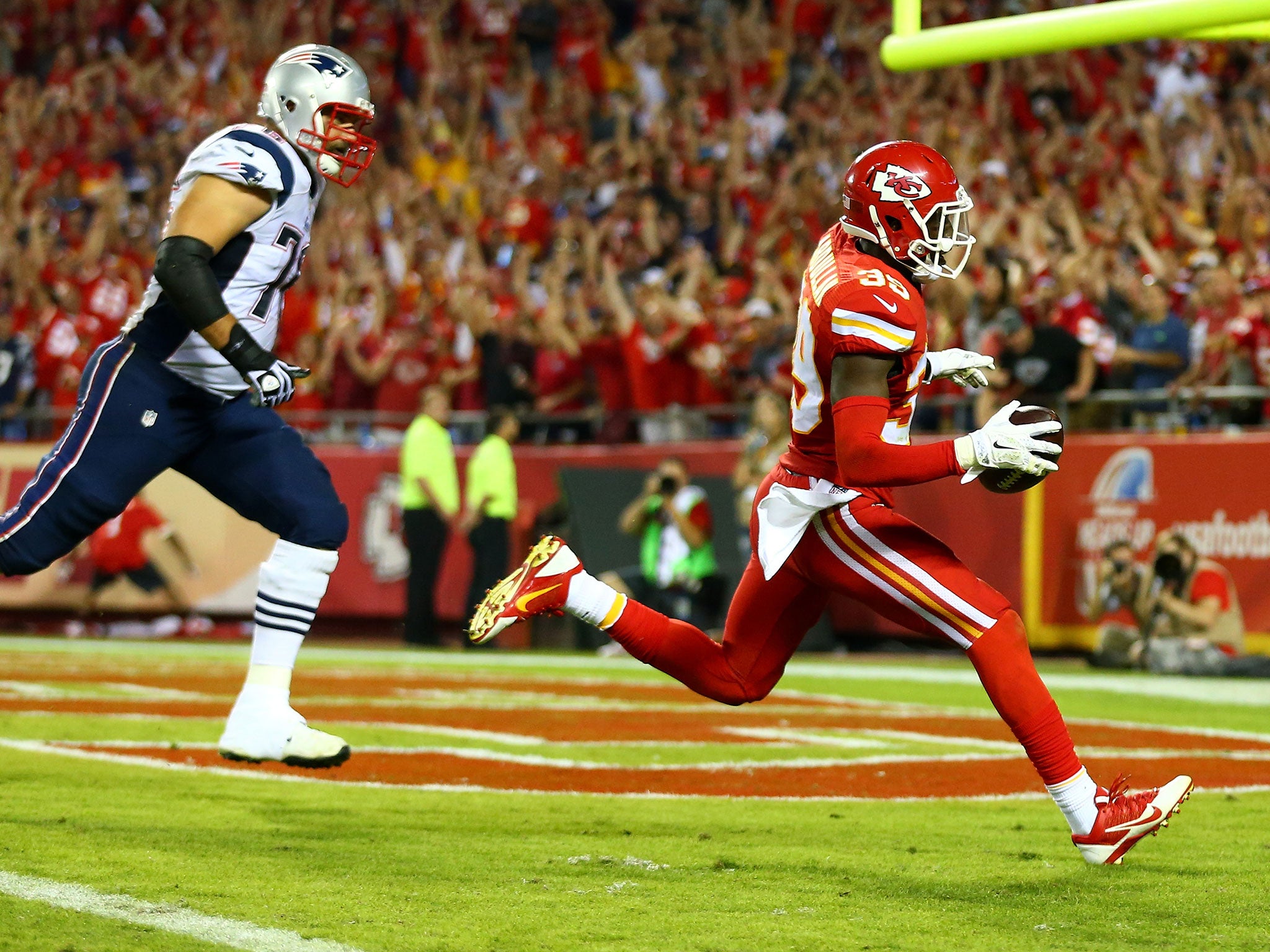 Husain Abdullah returns an interception off Tom Brady for a touchdown