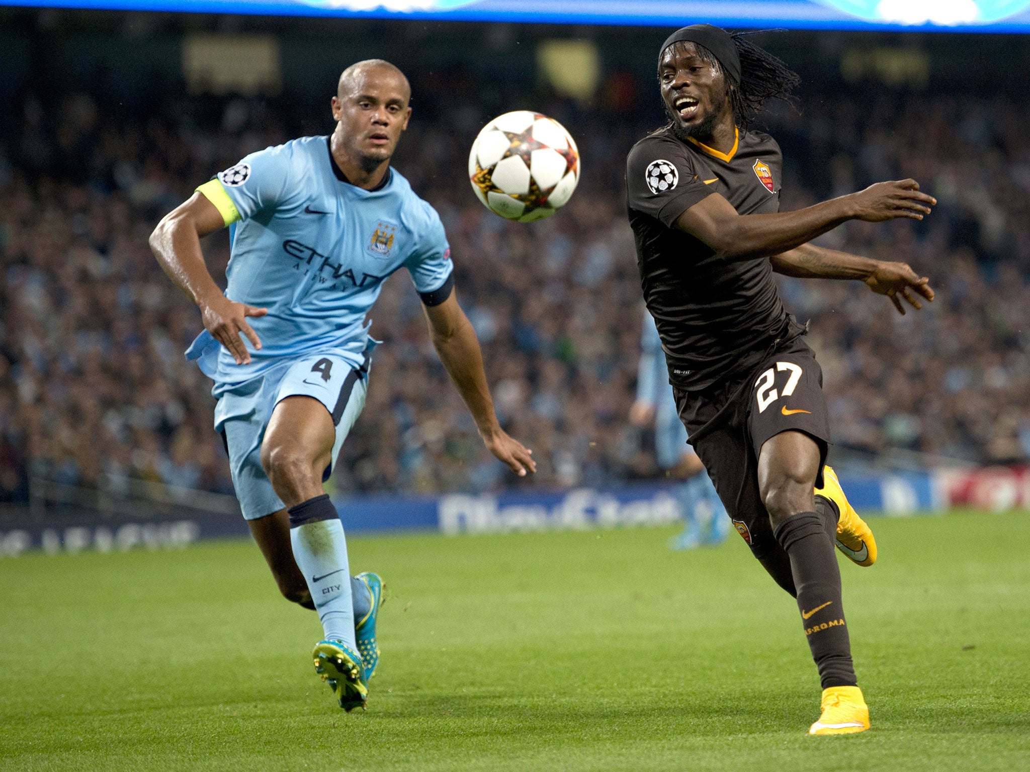 Vincent Kompany challenges Gervinho for the ball