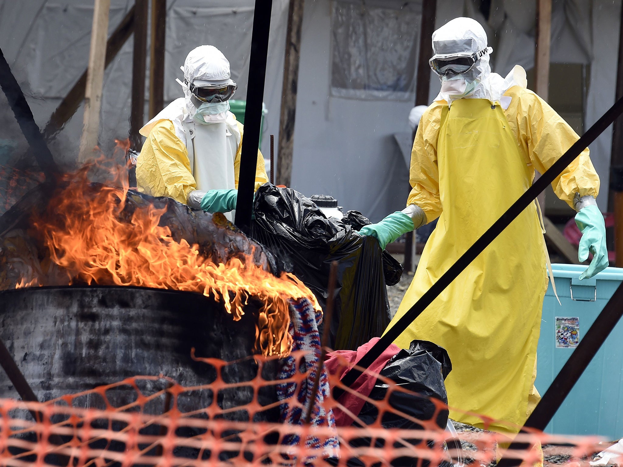 Medical staff members burn clothes belonging to patients suffering from Ebola, at the international medical NGO Medecins Sans Frontieres (MSF) in Monrovia