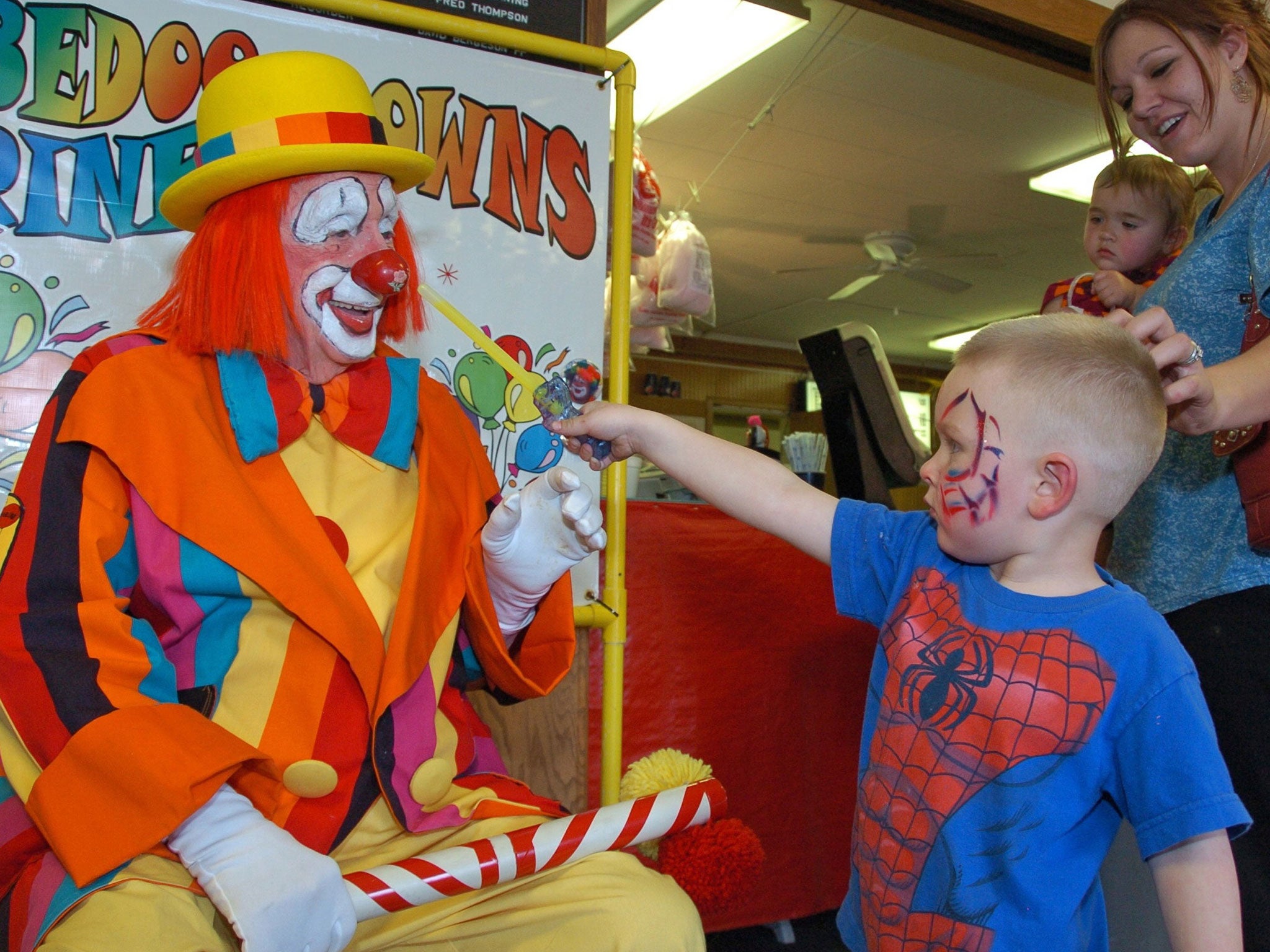 Floyd 'Creeky' Creekmore visits with a boy at a Shrine circus in Billings