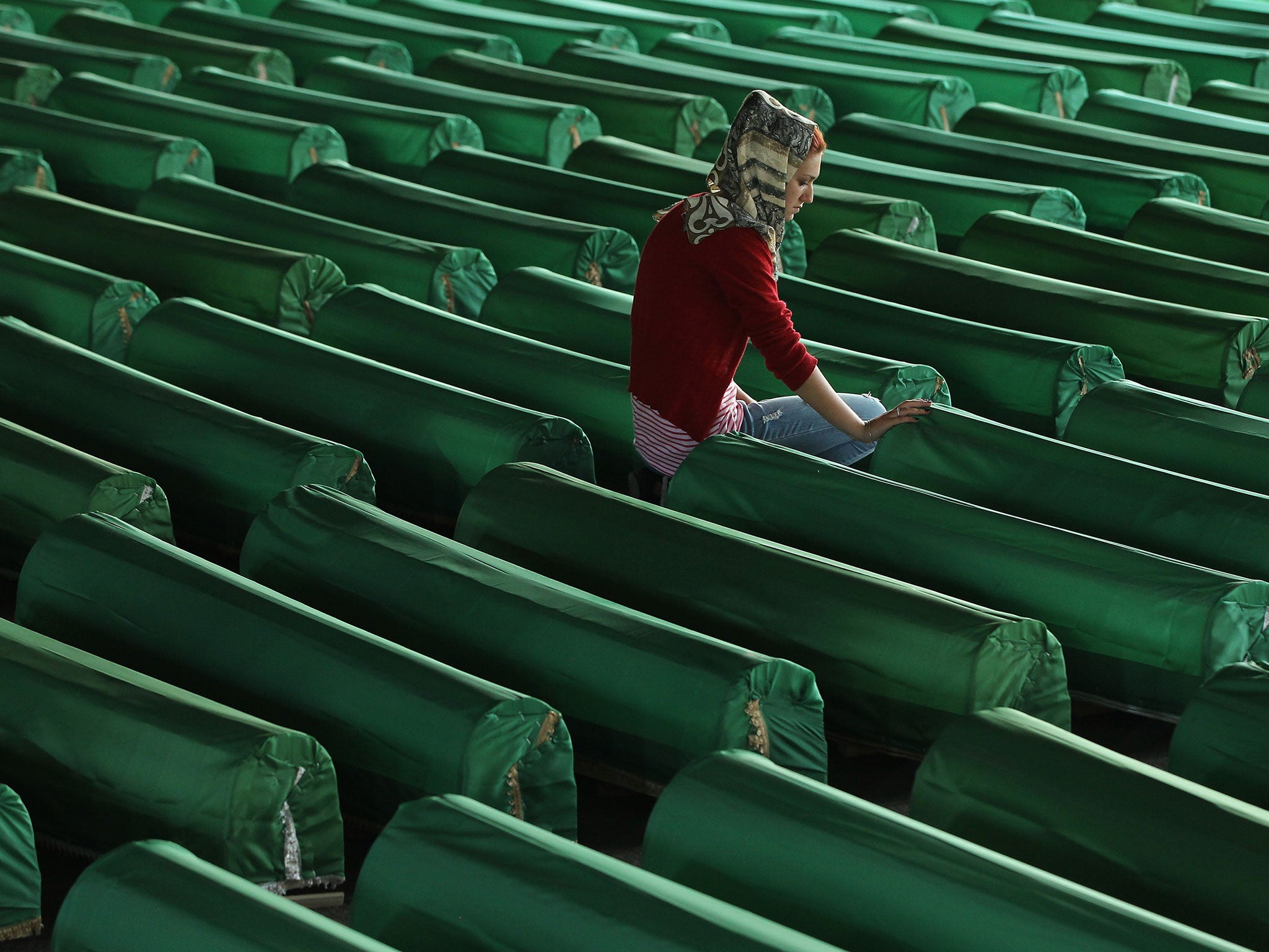 A young Muslim woman mourns over a coffin among hundreds of other victims of the 1995 Srebrenica massacre. At least 8,300 Bosnian Muslim men and boys were killed by members of the Bosnian Serb army under the leadership of General Ratko Mladic