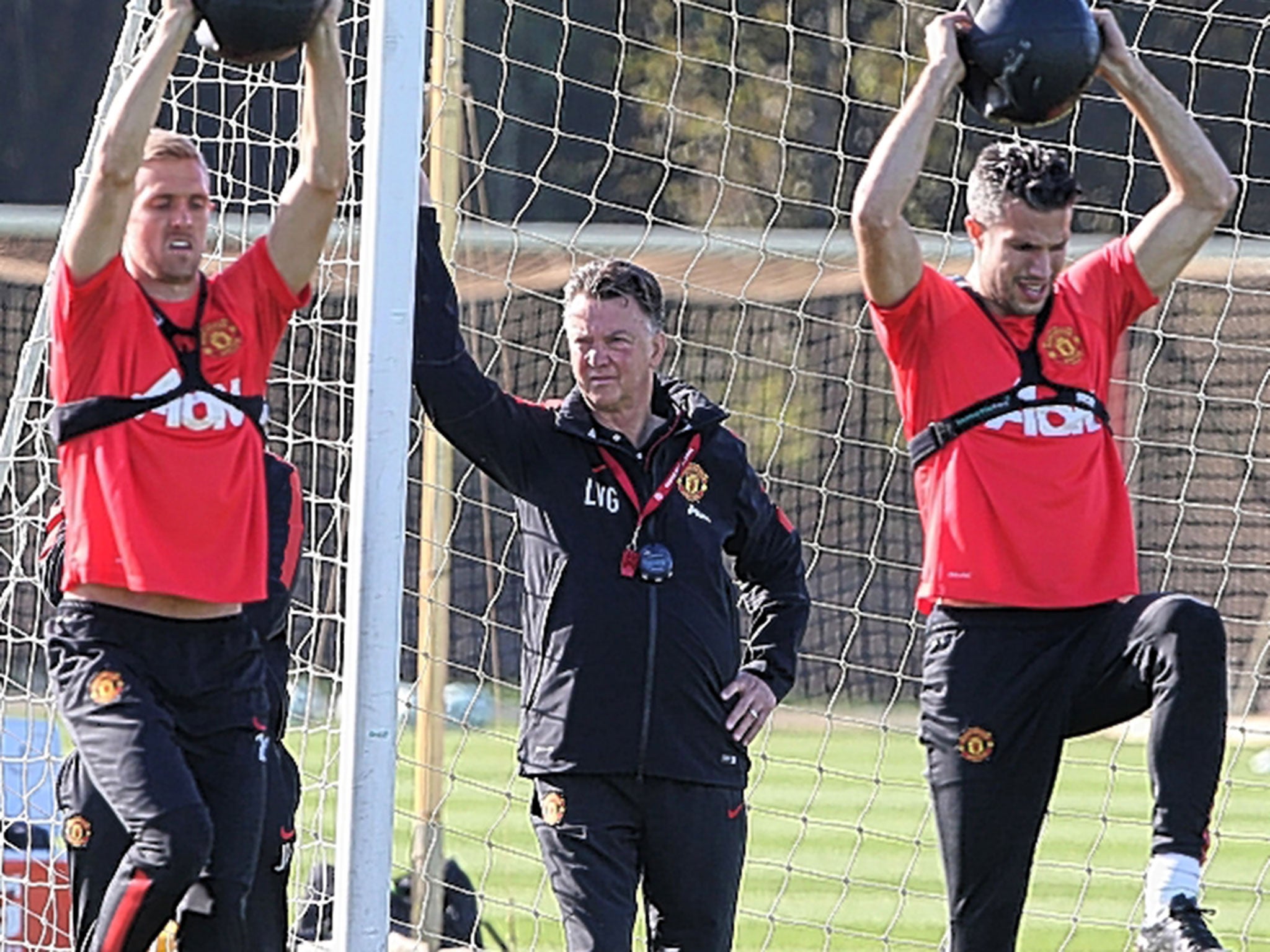 Louis van Gaal (centre) supervises training with the Manchester United squad