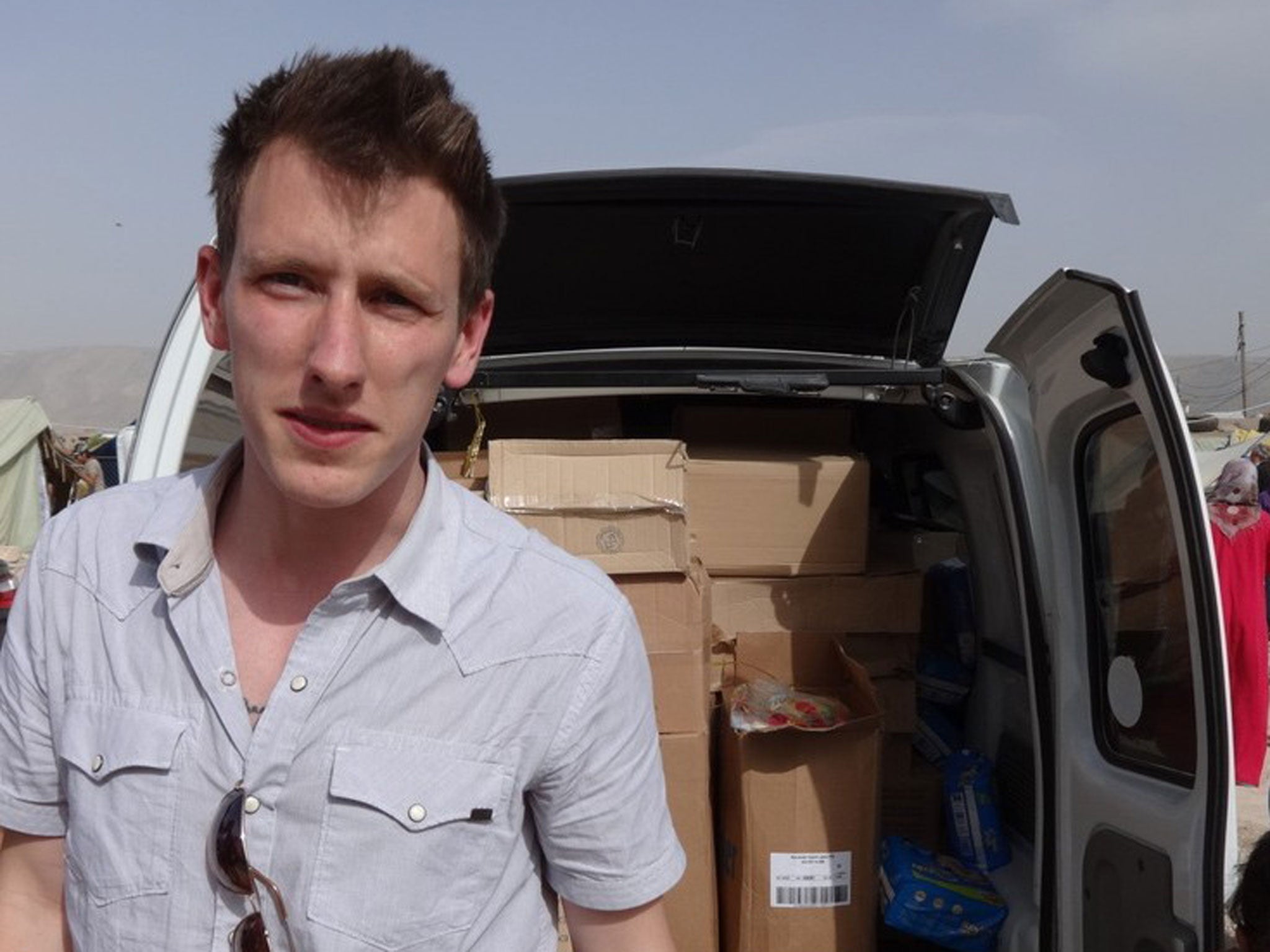 An undated photo provided by the Kassig Family shows Peter Kassig standing in front of a truck filled with supplies for Syrian refugees.