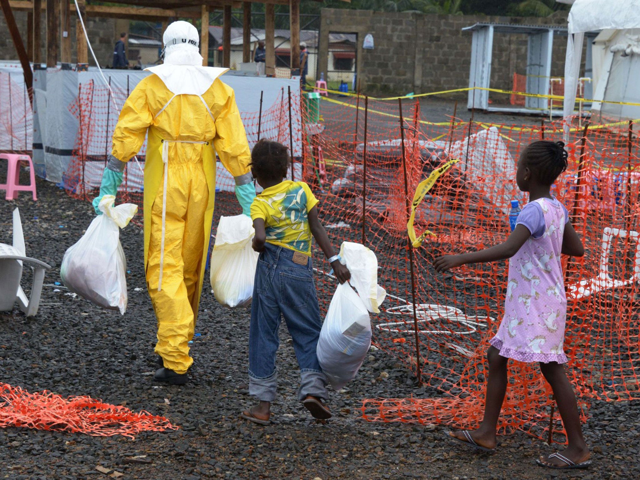 A medical worker with children in the high-risk area of the Elwa 3 centre run by Medécins Sans Frontières