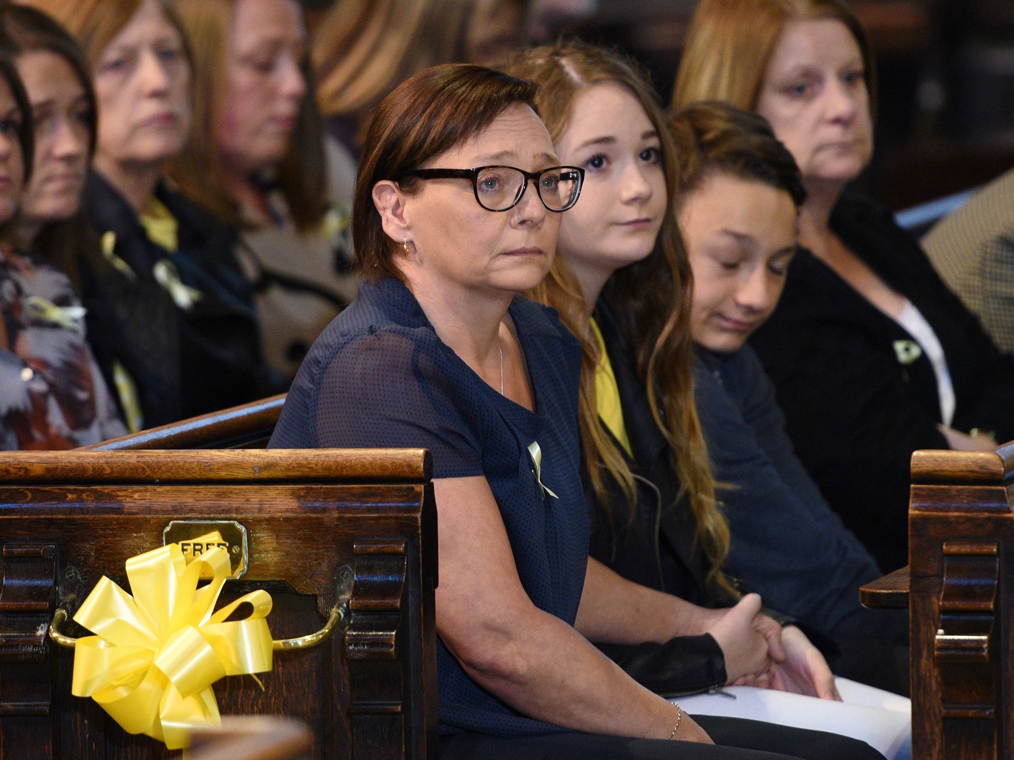 Alan Henning's widow, Barbara, and their children, Lucy and Adam, attend
a service of remembrance in Eccles Parish Church in Salford last night