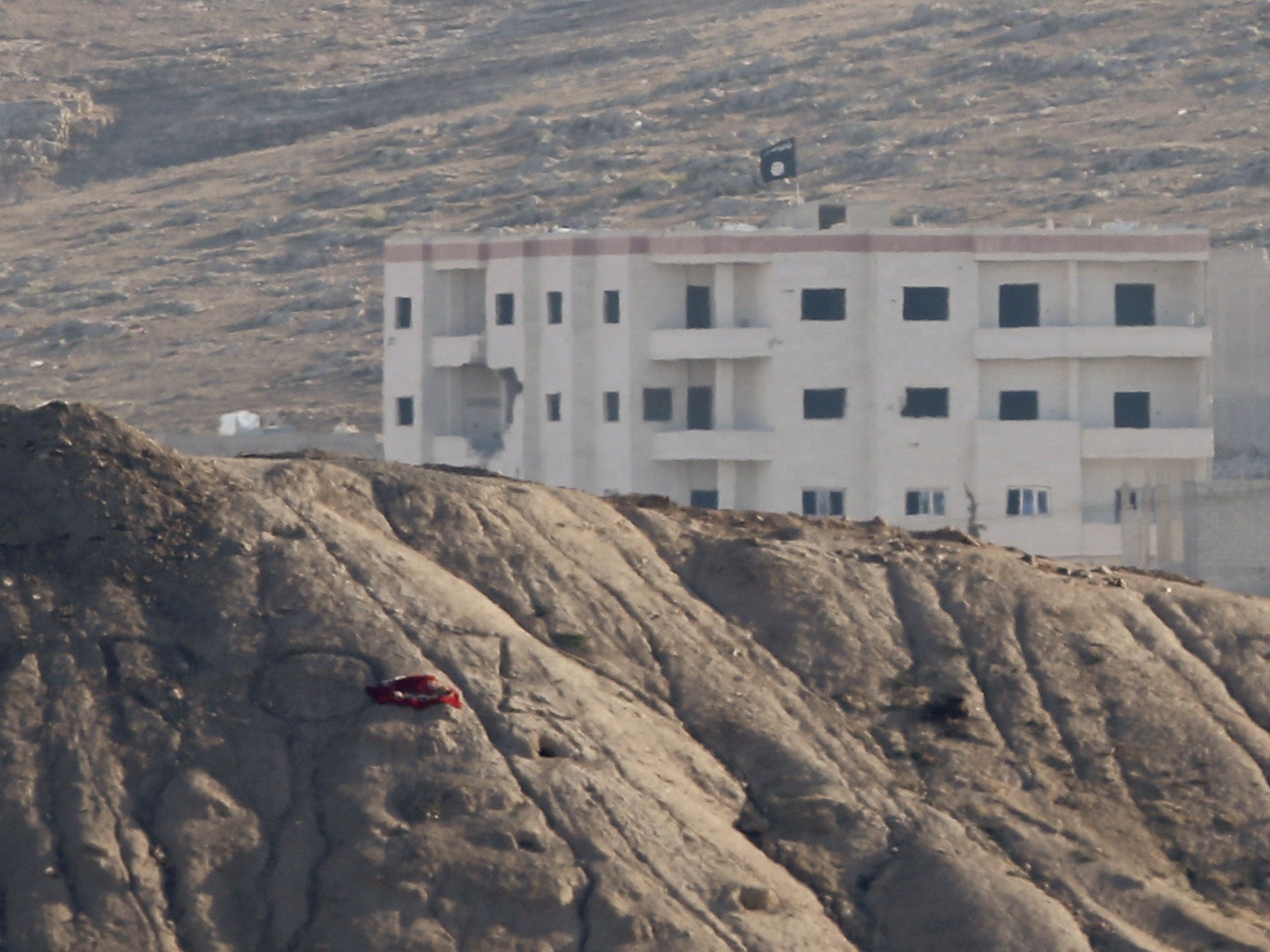 A black flag belonging to the Islamic State is seen near the Syrian town of Kobani, as pictured from the Turkish-Syrian border near the southeastern town of Suruc in Sanliurfa province, October 6, 2014