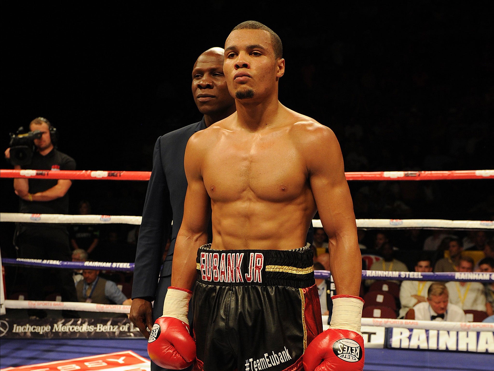 Chris Eubank Jr stands in front of Chris Eubank Sr