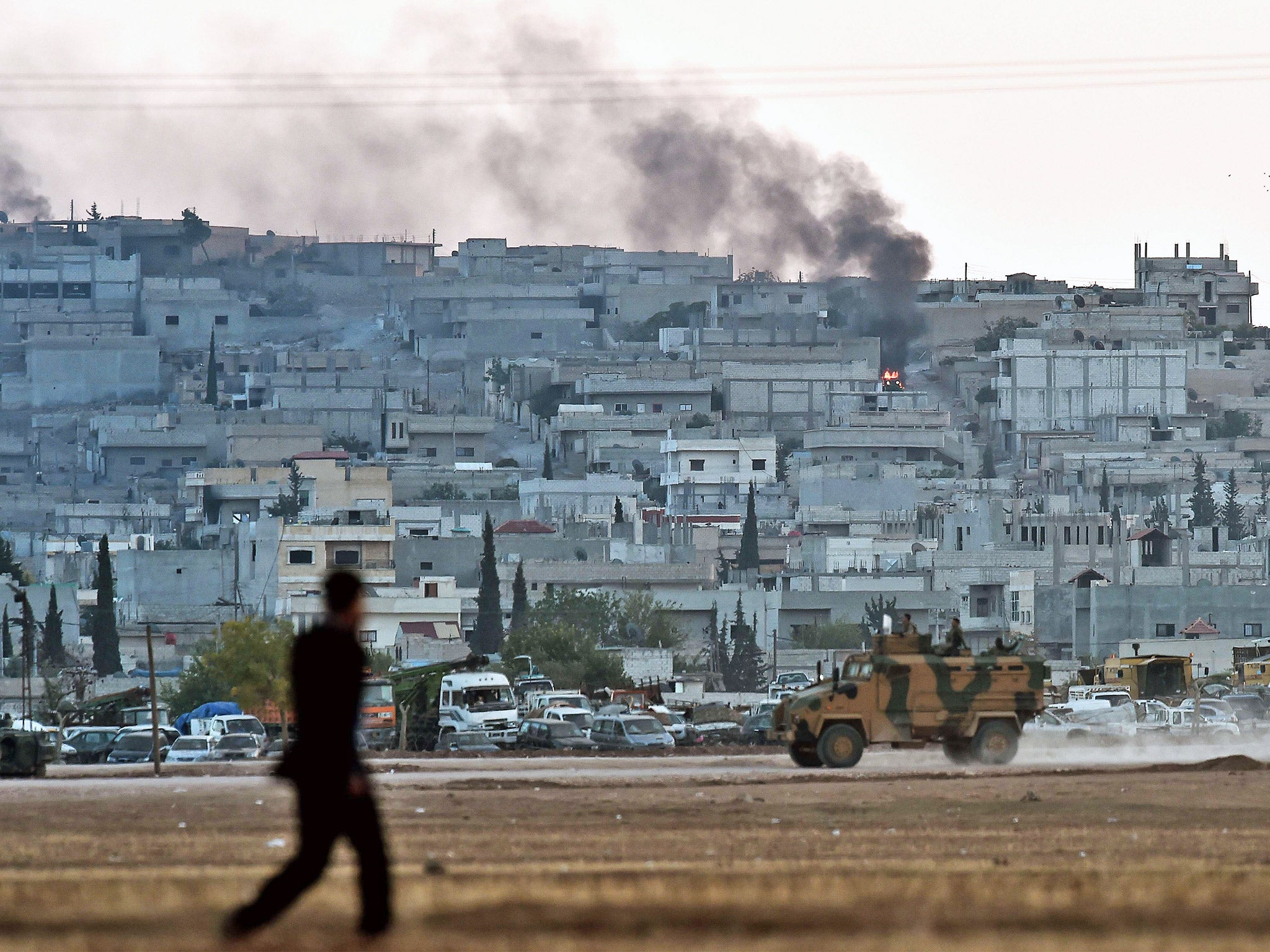 Smoke rises from the city centre of Kobani (Getty)