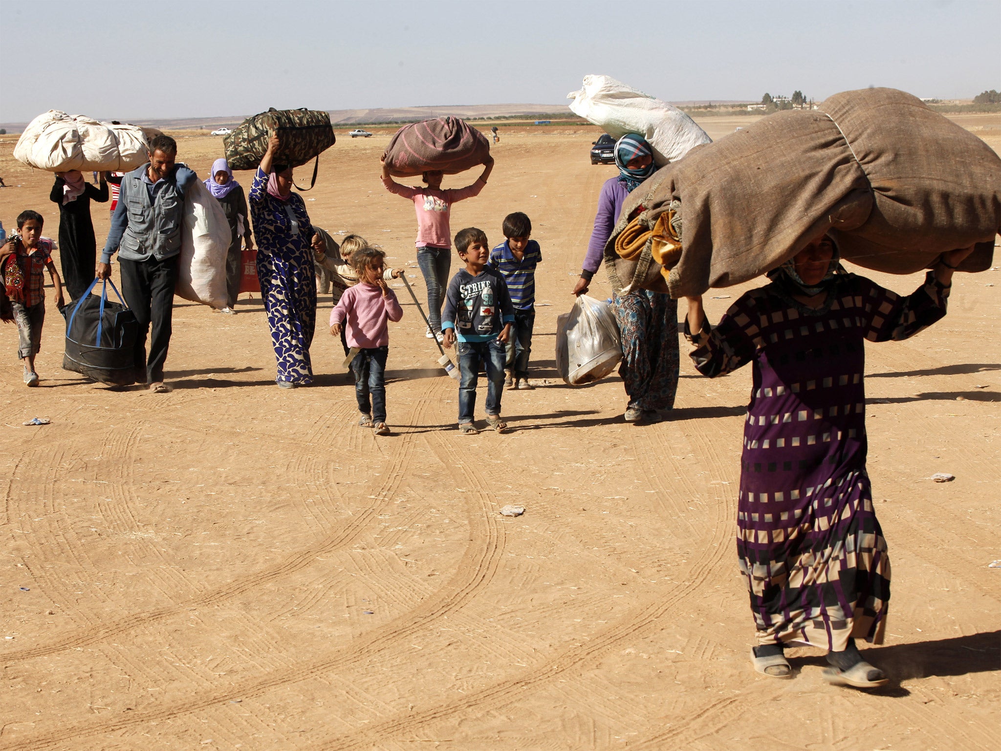 Newly arrived Kurdish refugees after crossing into Turkey from the Syrian border town of Kobani (Getty)