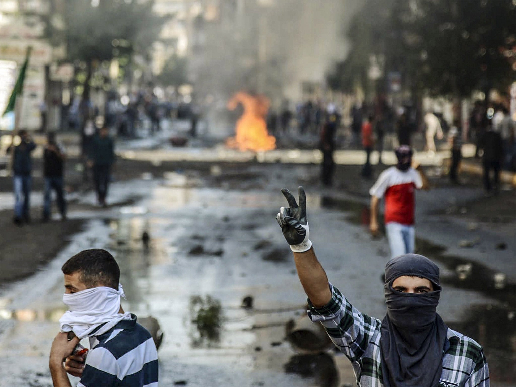 Kurdish protesters clash with Turkish riot police in the south-eastern city of Diyarbakir yesterday, as the Turkish government refused to help Syrian Kurds in the border city of Kobani